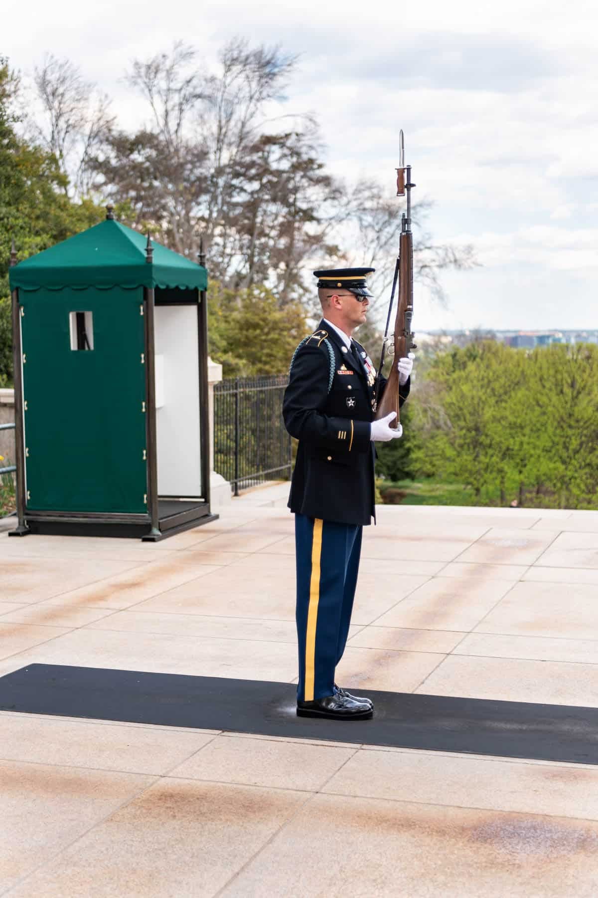A soldier guarding the tomb of the unknown soldier at Arlington National Cemetery.