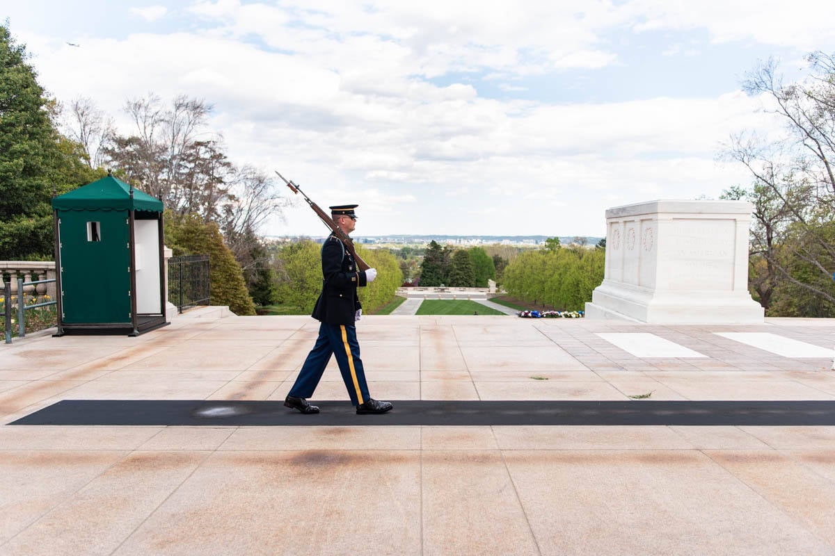 A soldier guarding the tomb of the unknown soldier at Arlington National Cemetery.
