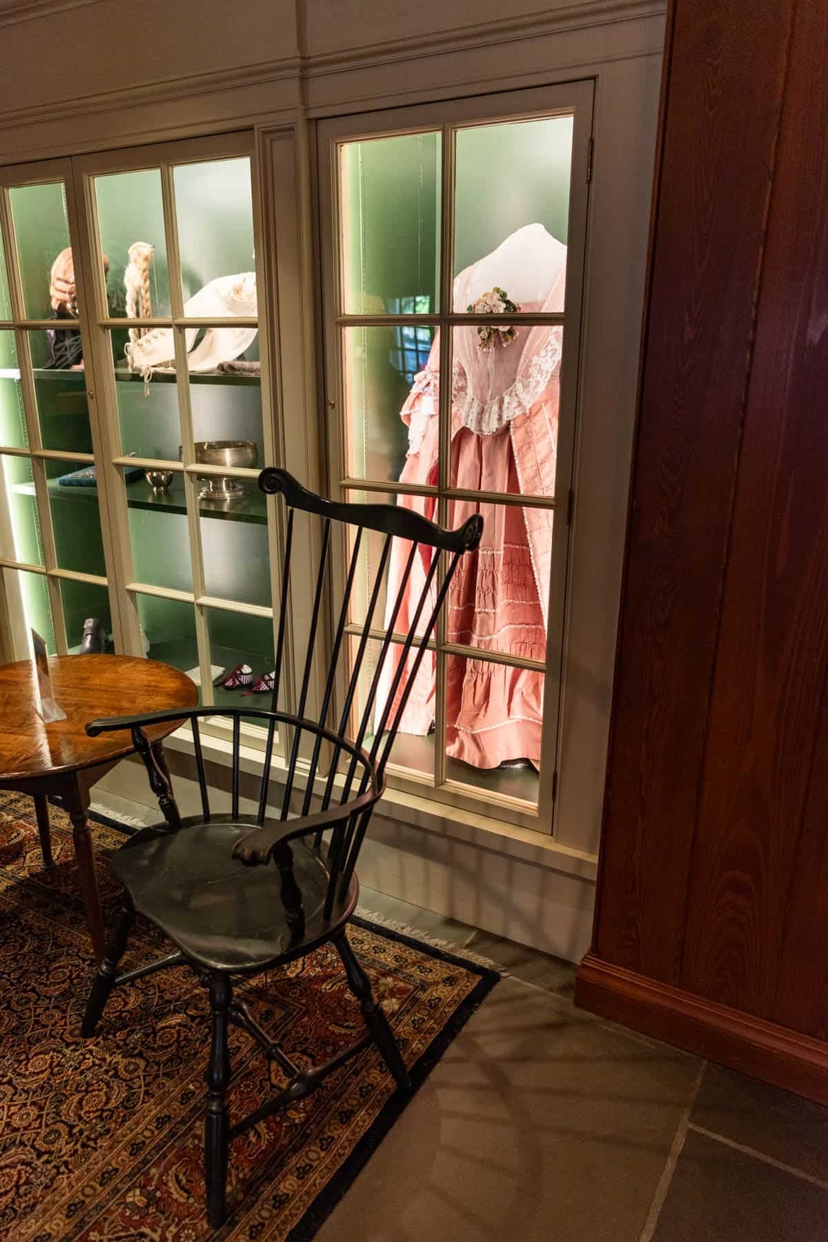 A colonial gown behind a glass display.