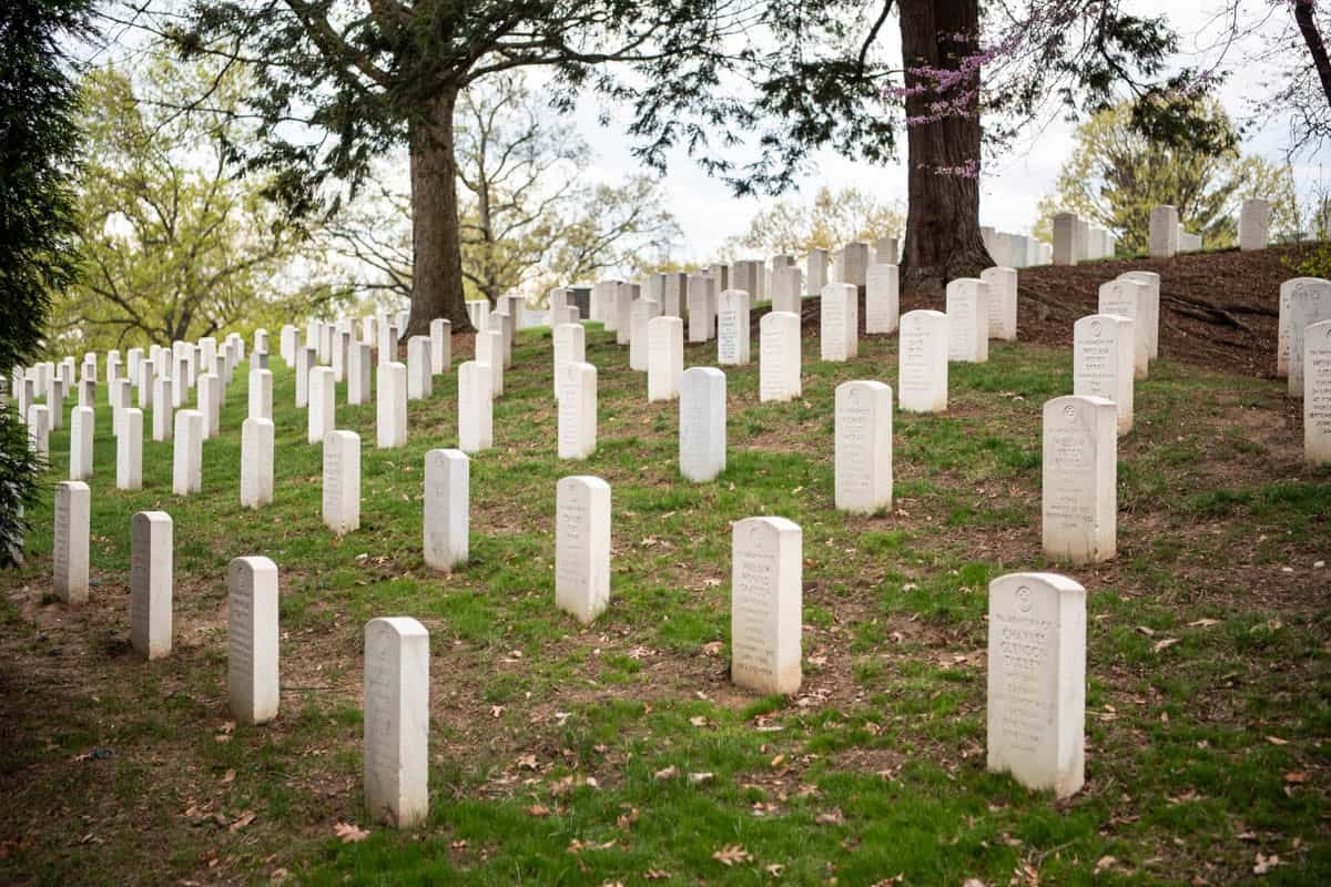 White markers in rows at Arlington National Cemetery.