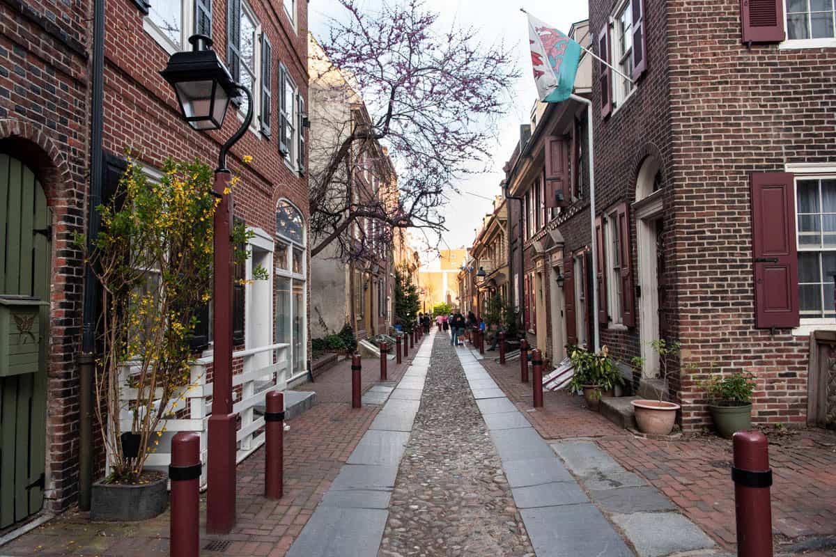 Elfreth's Alley with a cobblestone street running down the center.