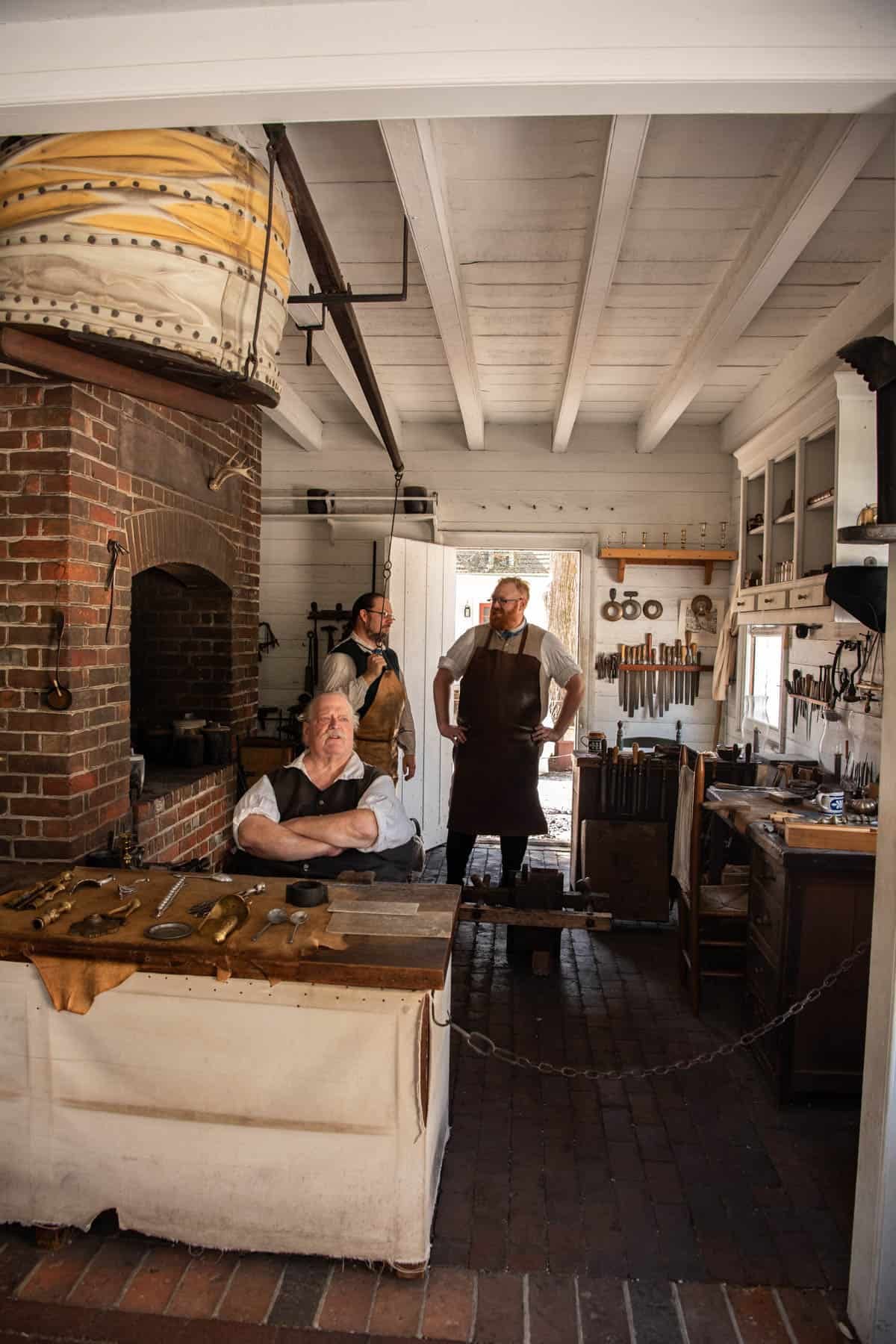 Men in a blacksmith shop in Colonial Williamsburg.