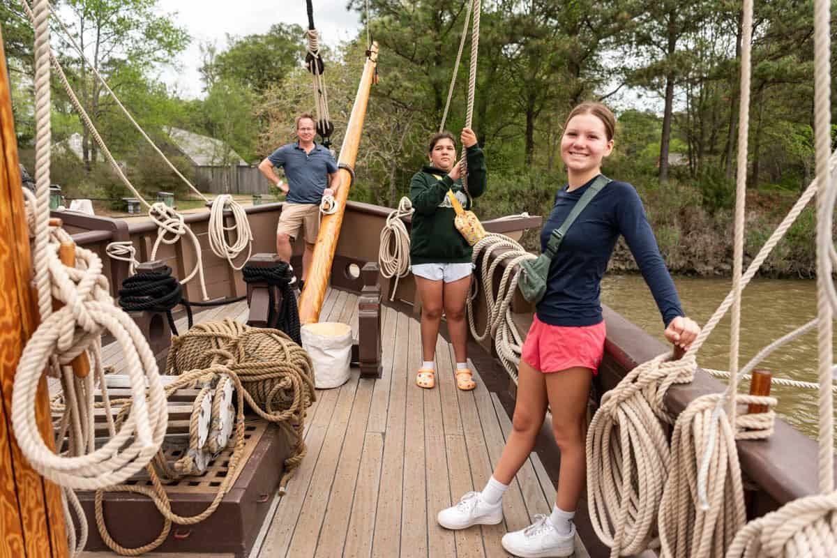 A dad and two daughters on a replica sailing ship from Jamestown colony, Virginia.