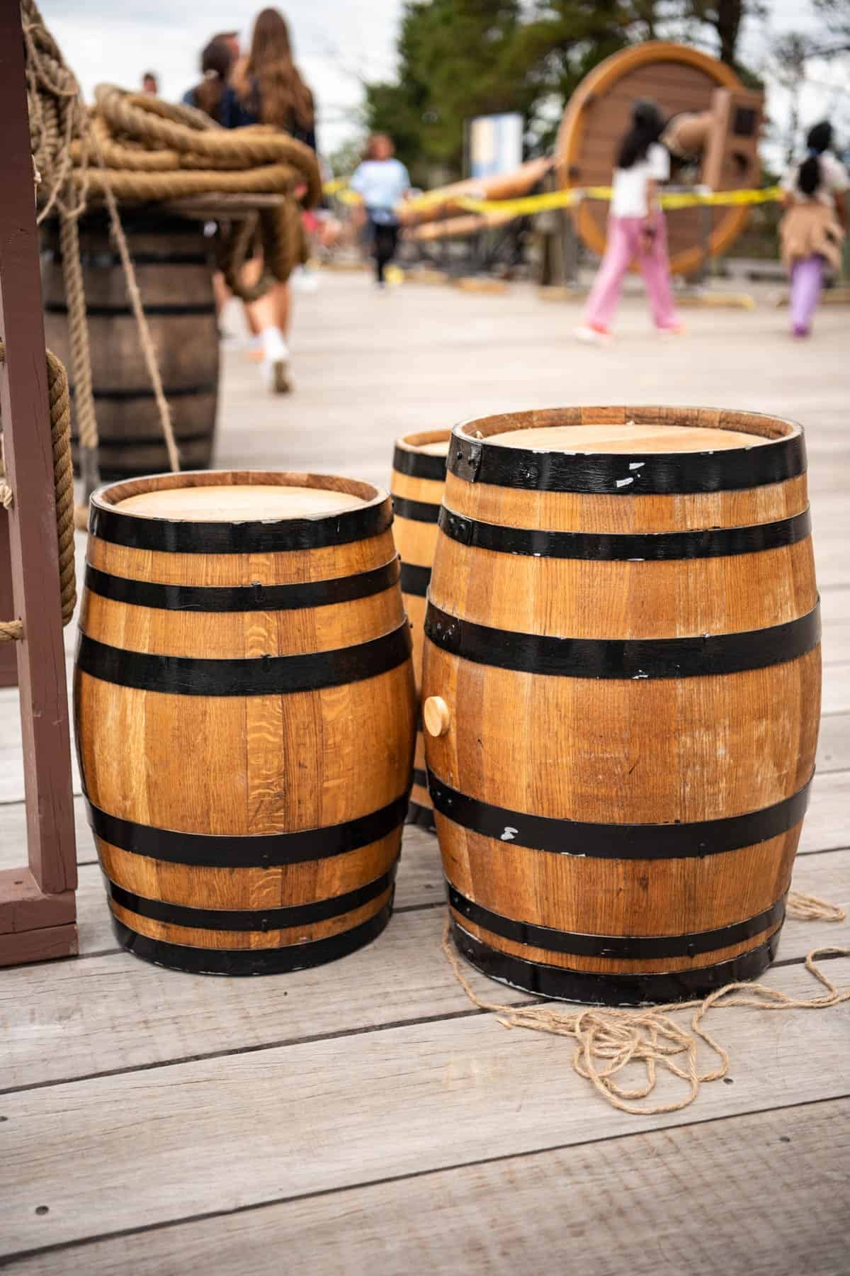 An image of wooden kegs on a dock.