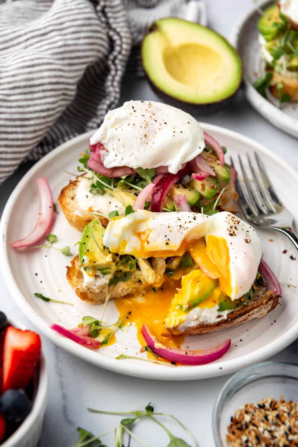 Avocado toast with a runny poached egg on top.