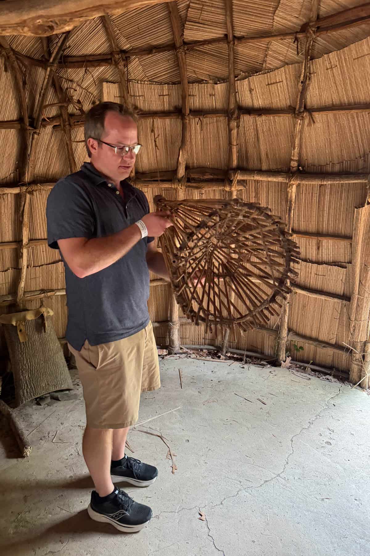 A man holding a fish trap.