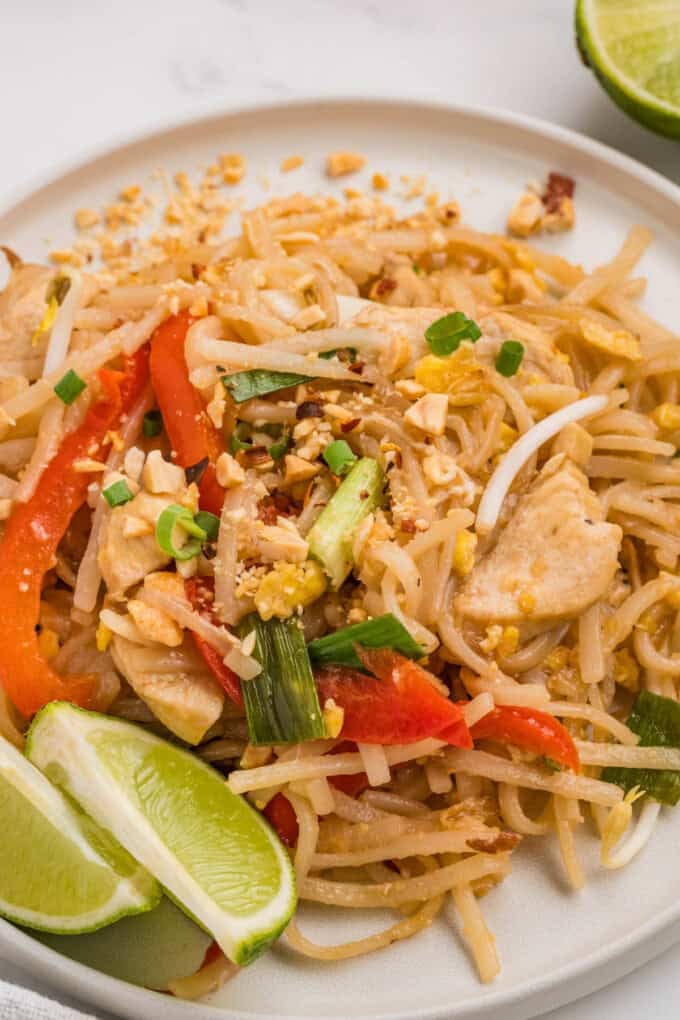 A close up image of pad thai noodles on a plate.
