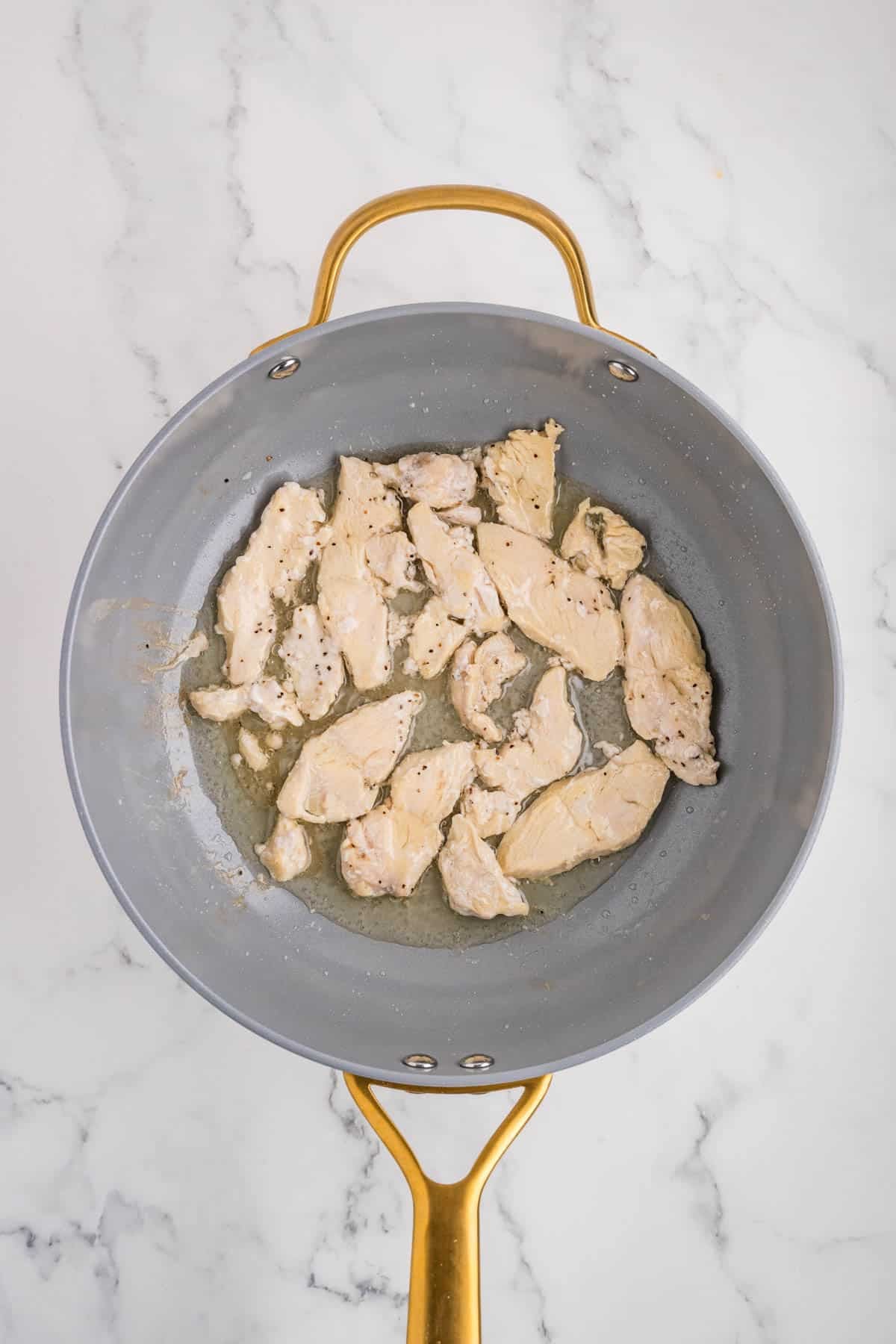 Cooked chicken in a skillet.
