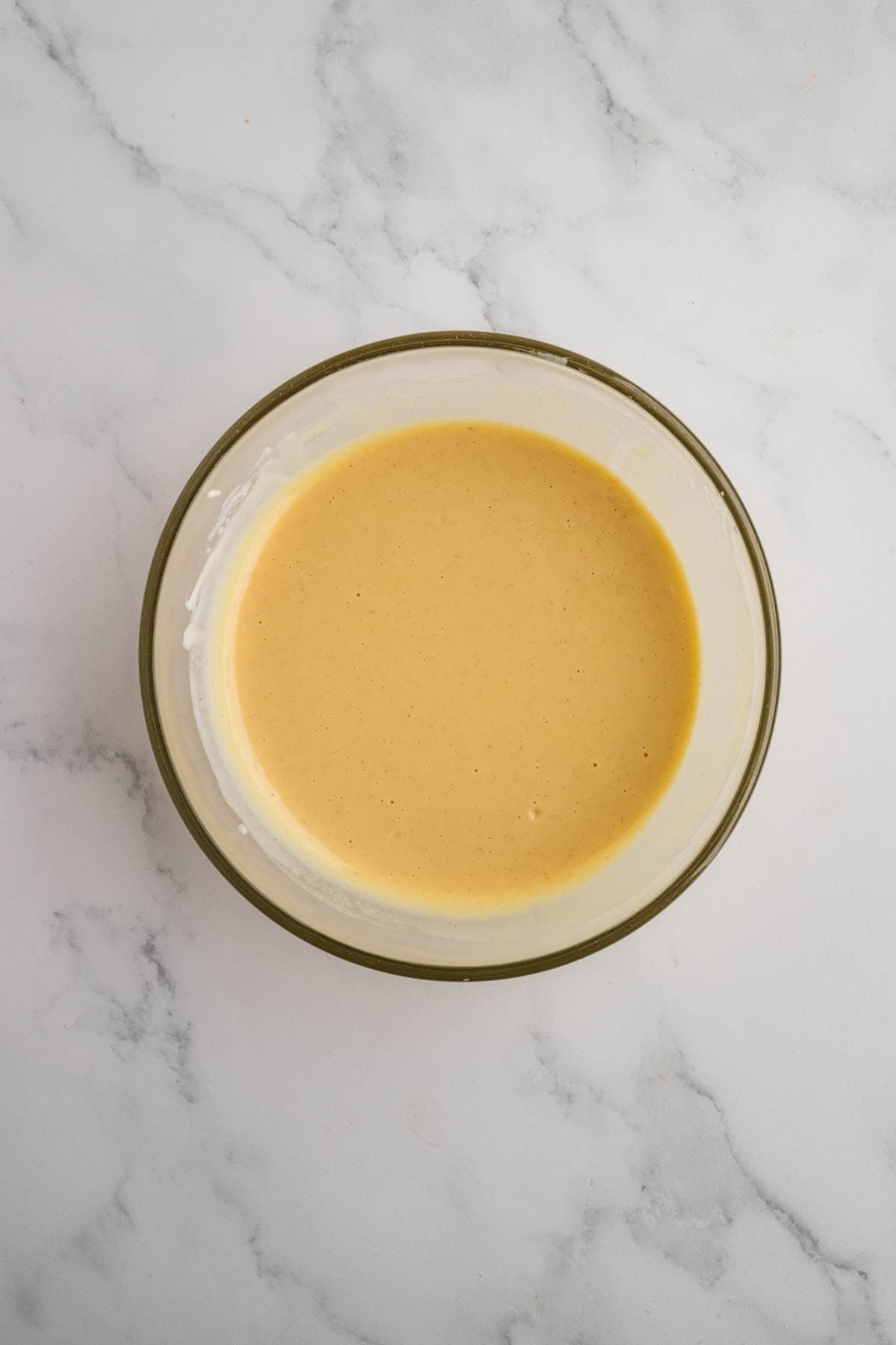 Honey mustard sauce in a glass bowl.