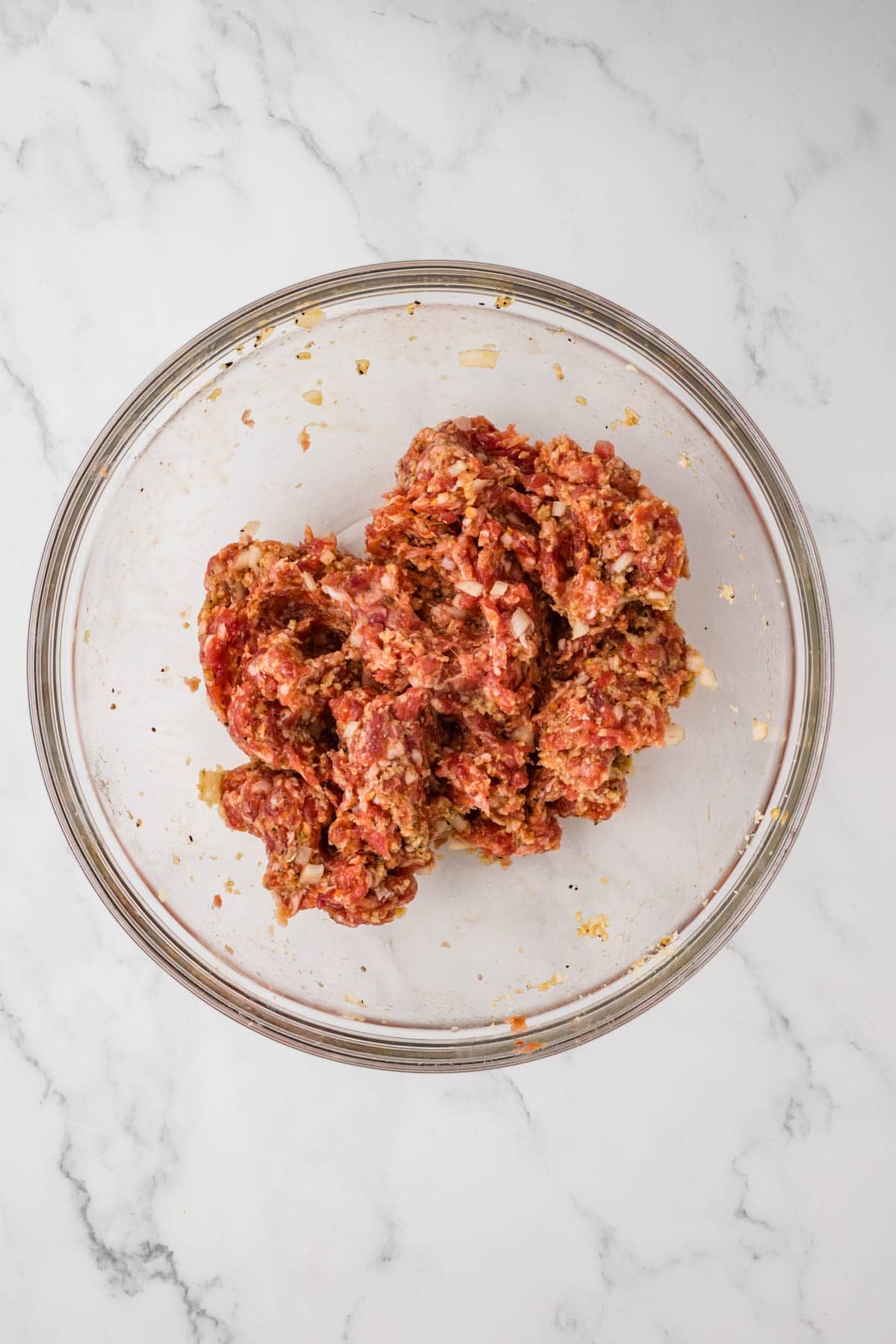Sausage filling in a glass bowl.