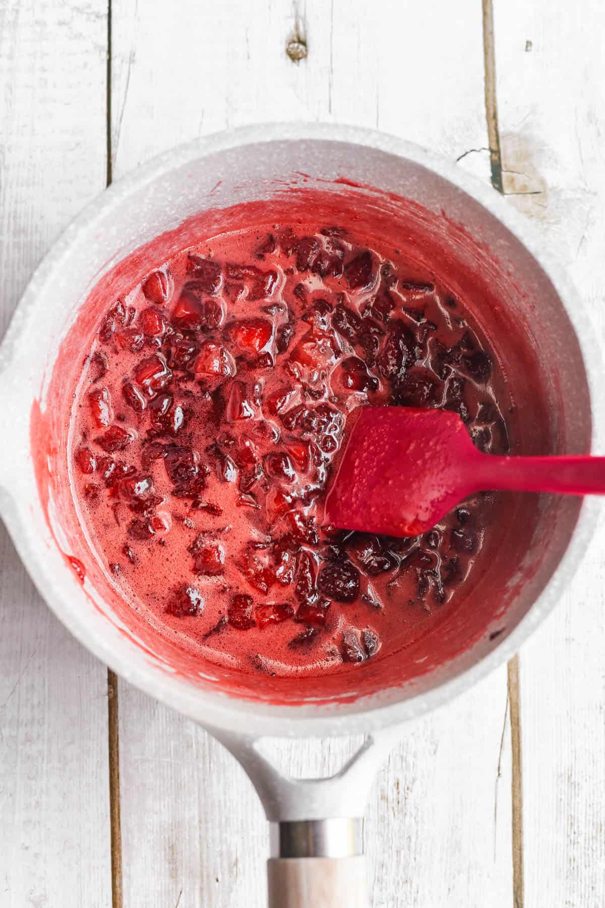 Making the strawberry topping for strawberry pretzel cookies.