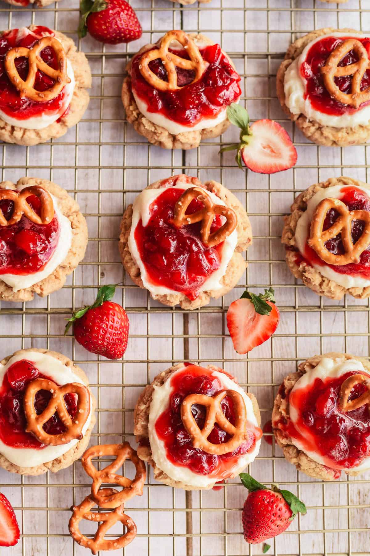 Strawberry pretzel cookies on a wire rack.