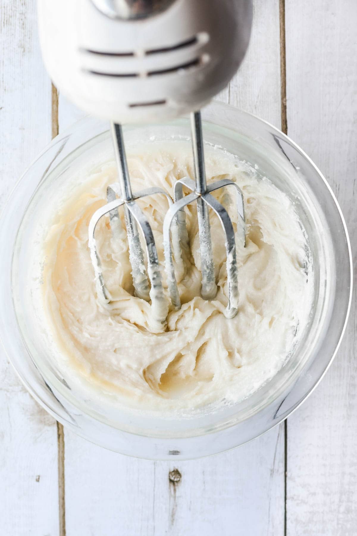 Making a creamy frosting for strawberry pretzel cookies.