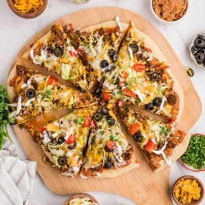 An overhead image of a sliced taco pizza.