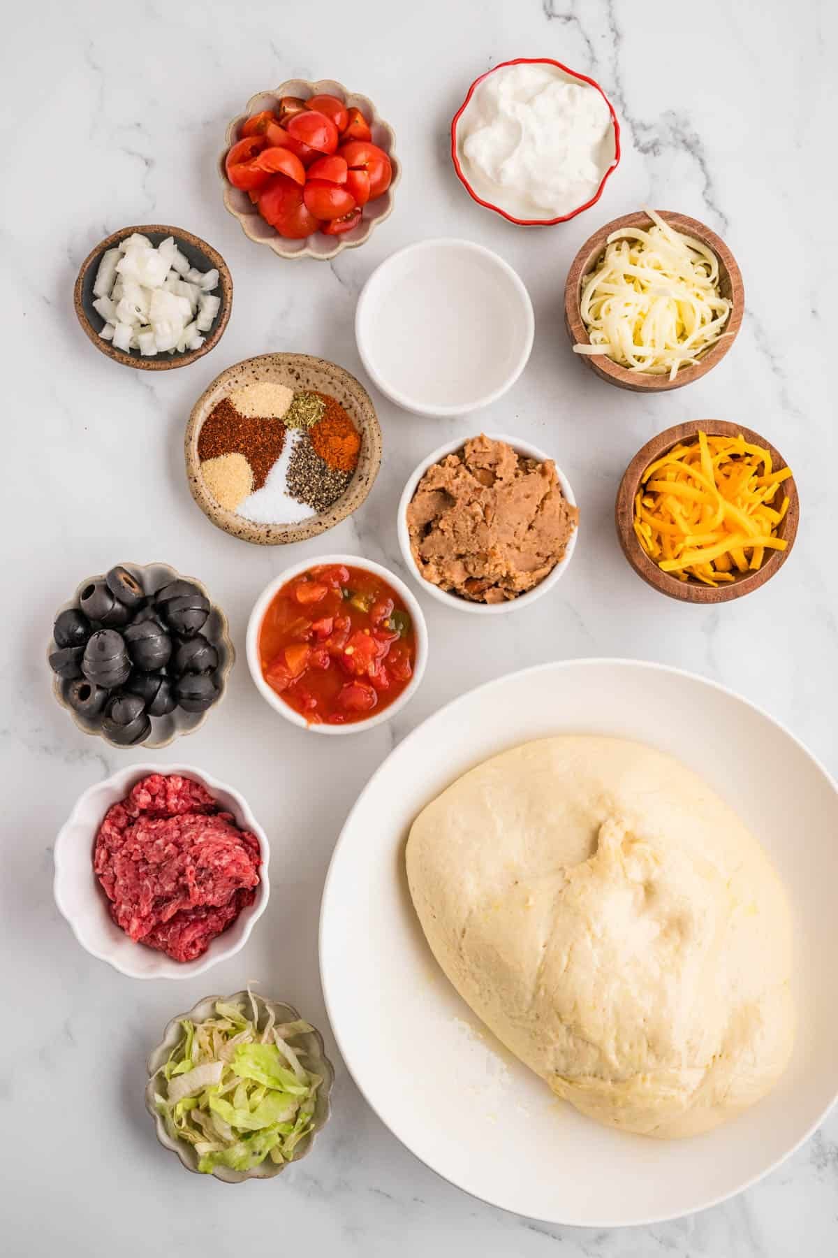 Ingredients for making a taco pizza.