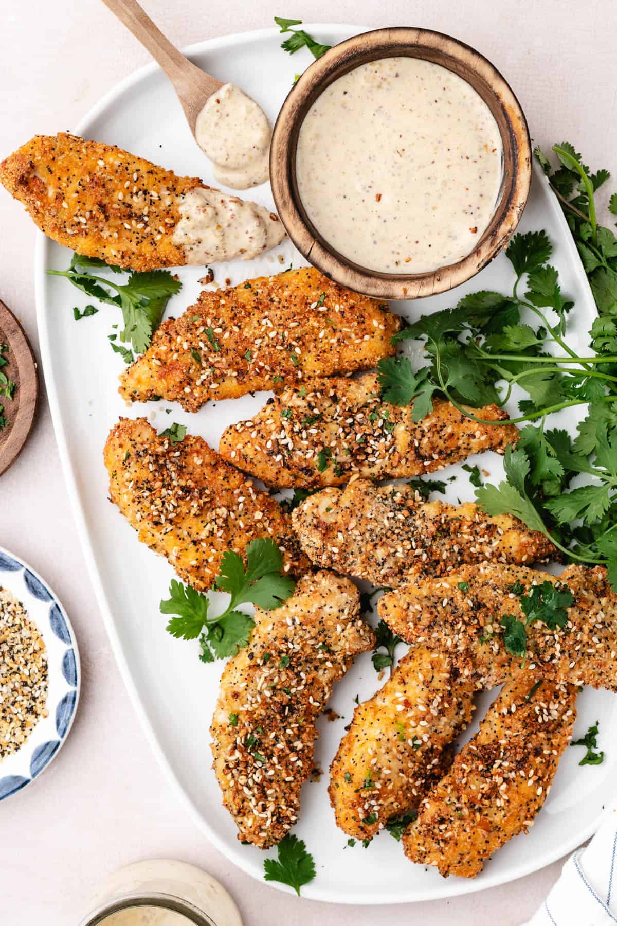 An overhead image of a platter of baked chicken tenders.