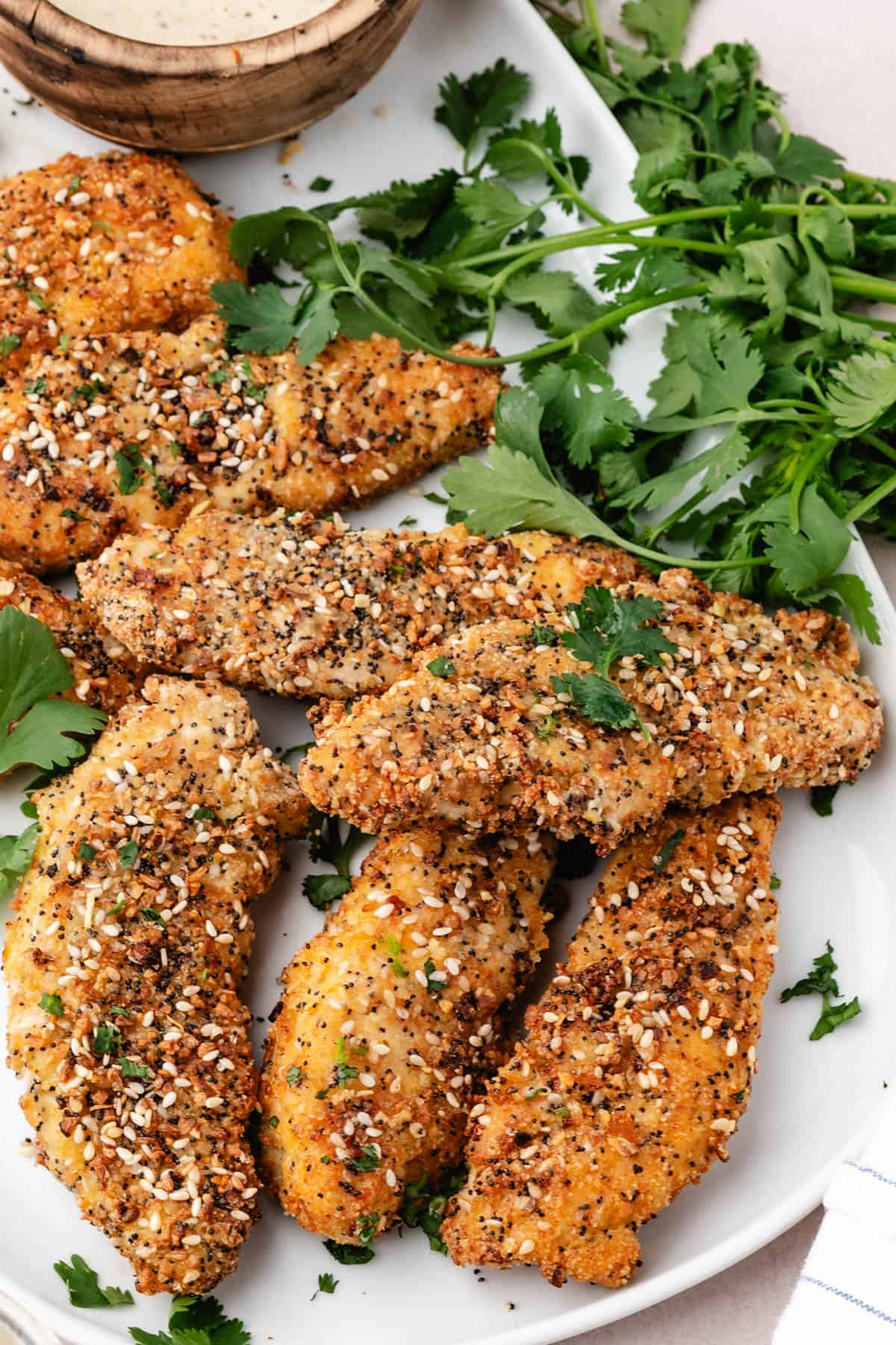 An image of everything bagel baked chicken tenders on a plate.