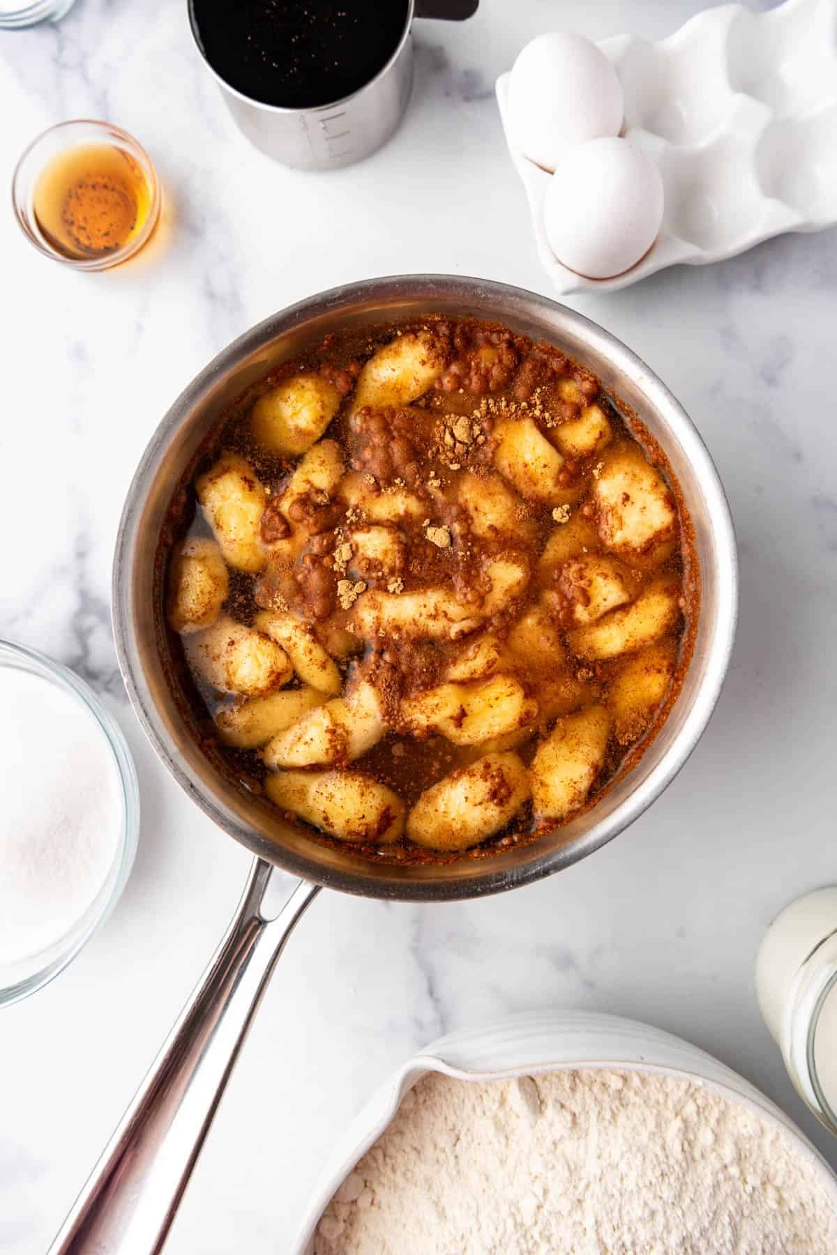 Dried apples in a saucepan with water and spices.