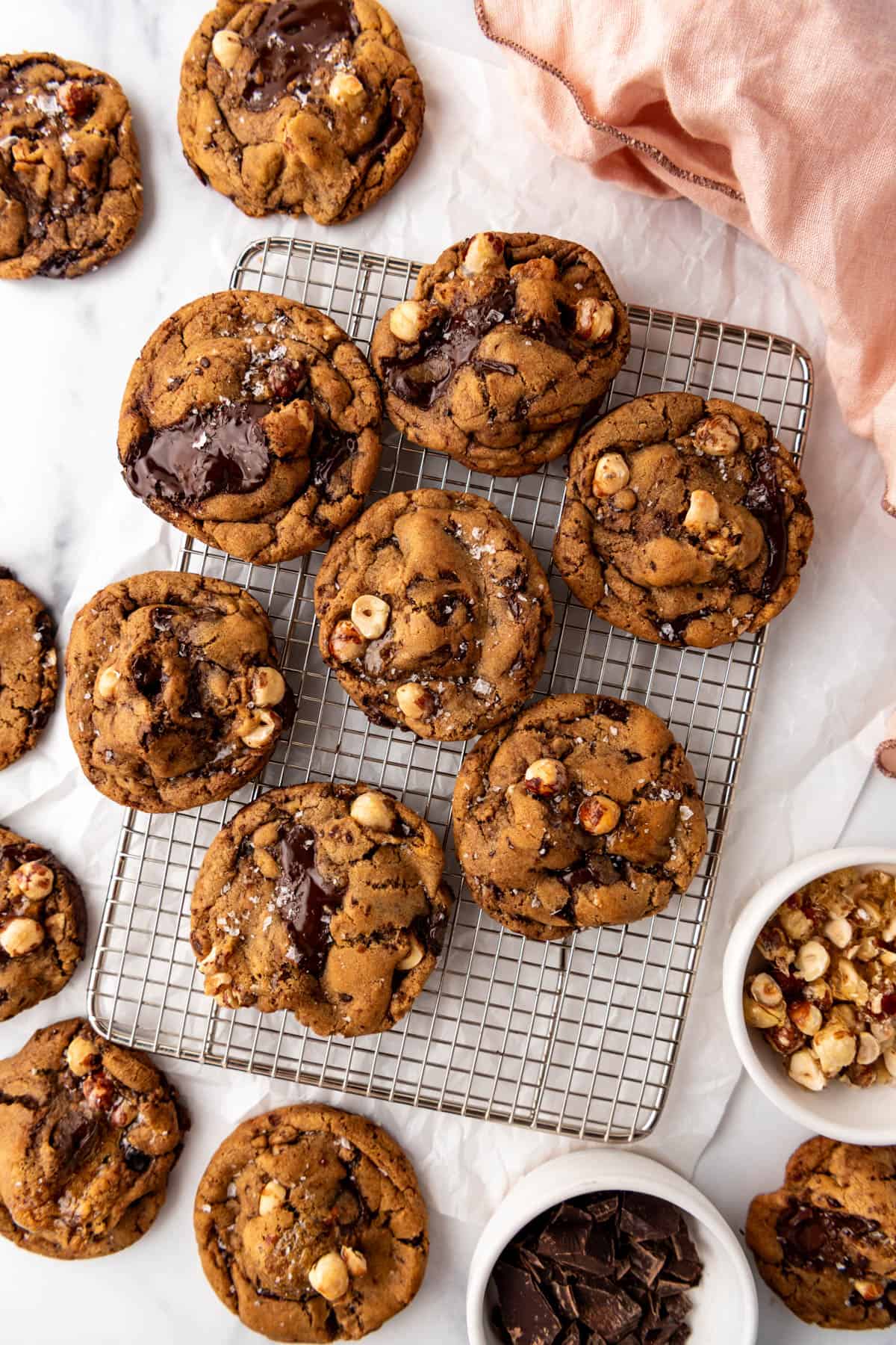 An overhead image of brown butter hazelnut chunk cookies on a wire rack.