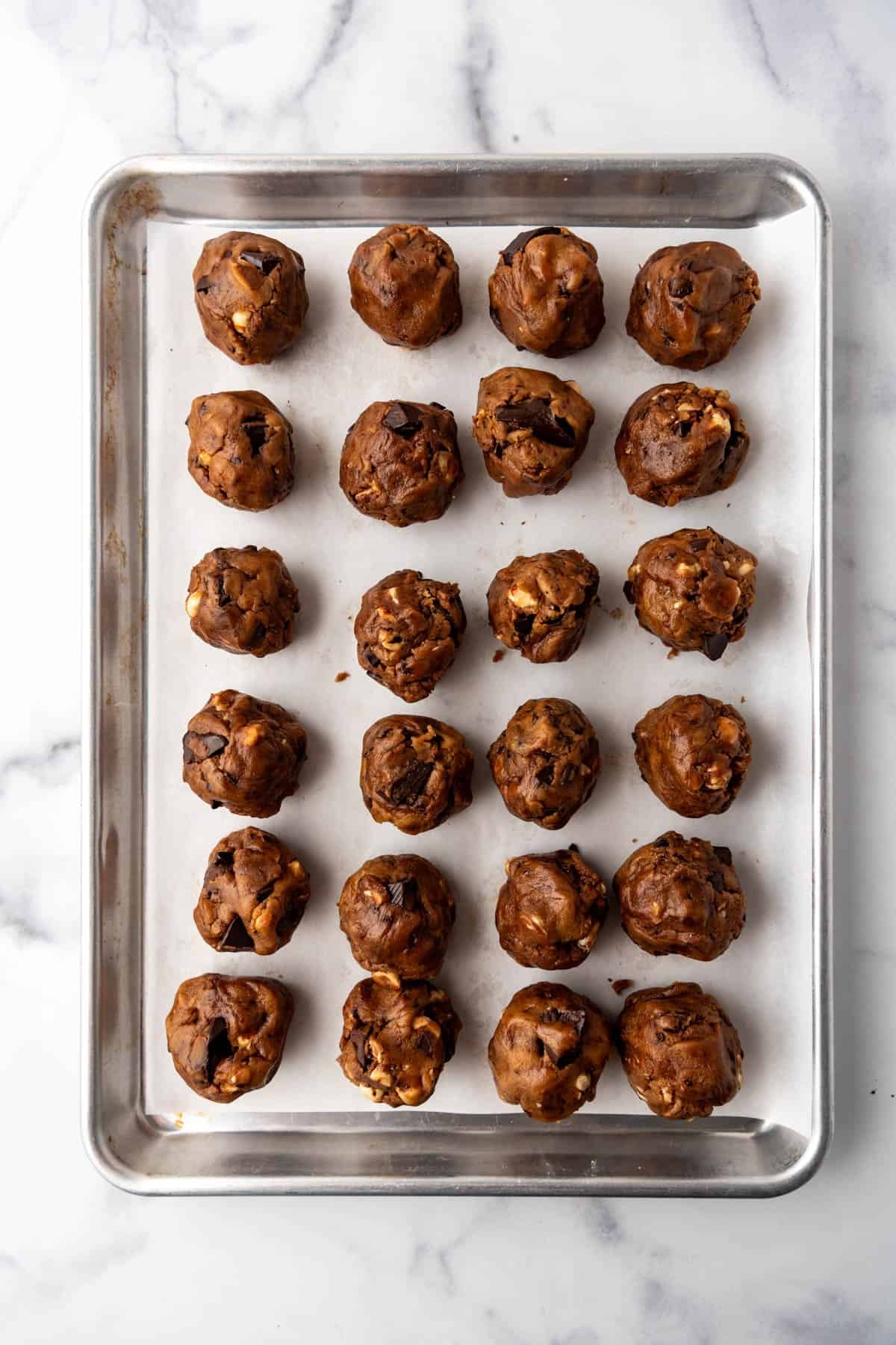 Balls of cookie dough on a baking sheet.