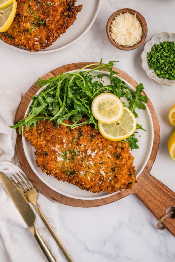 A plated dish of chicken milanese.