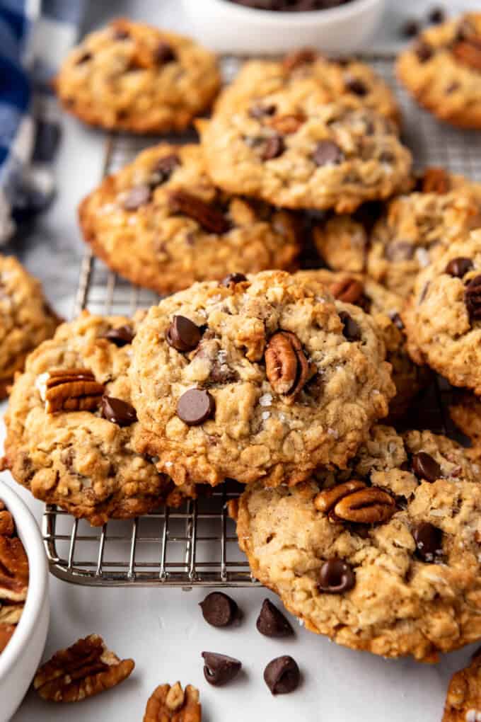 An image of cowboy cookies with chocolate chips and pecans on top.
