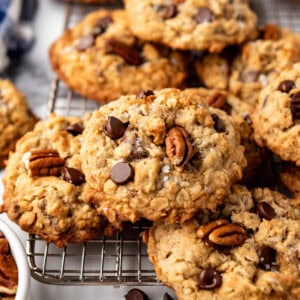 An image of cowboy cookies with chocolate chips and pecans on top.