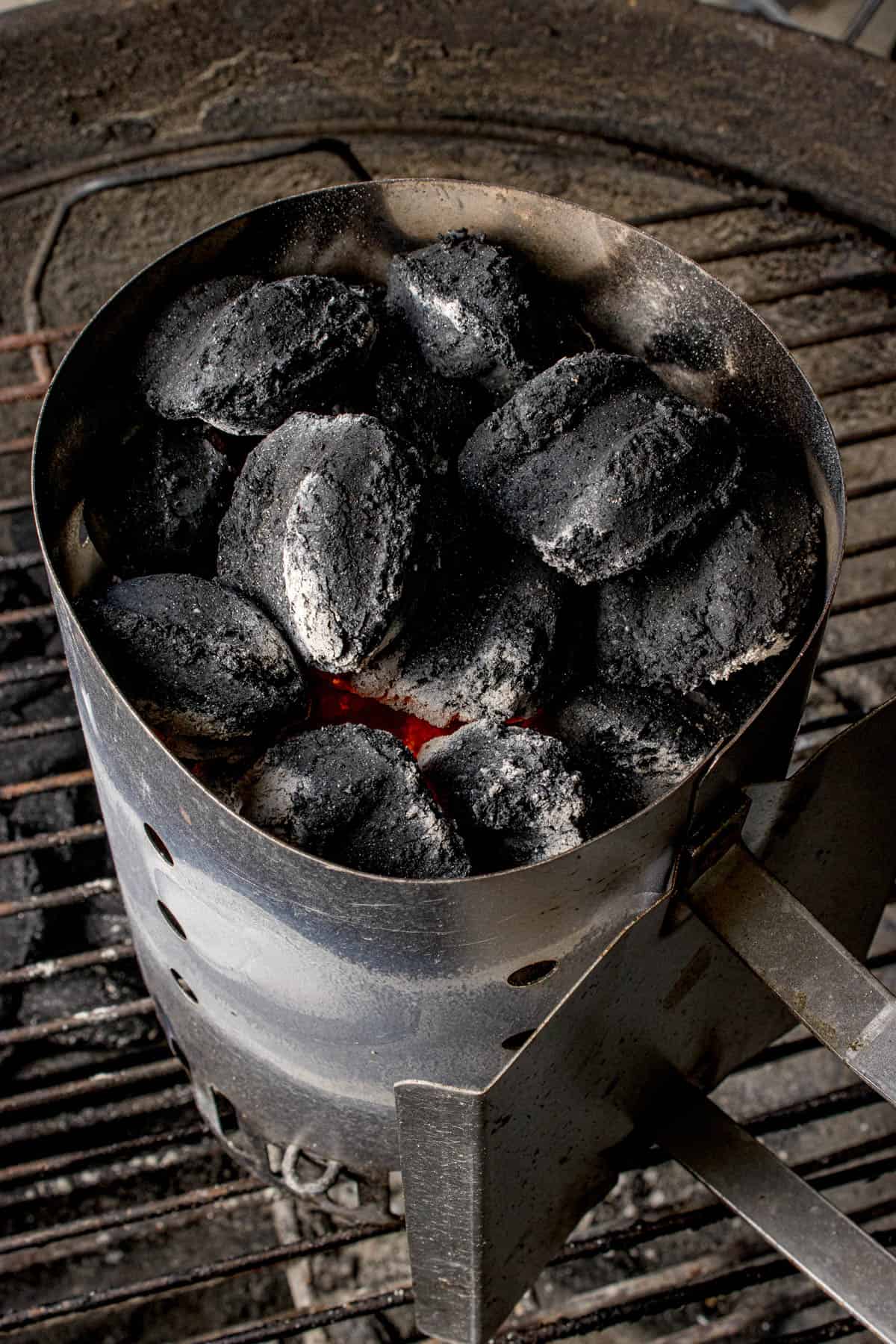 Charcoal briquettes that are just starting to turn grey around the edges.