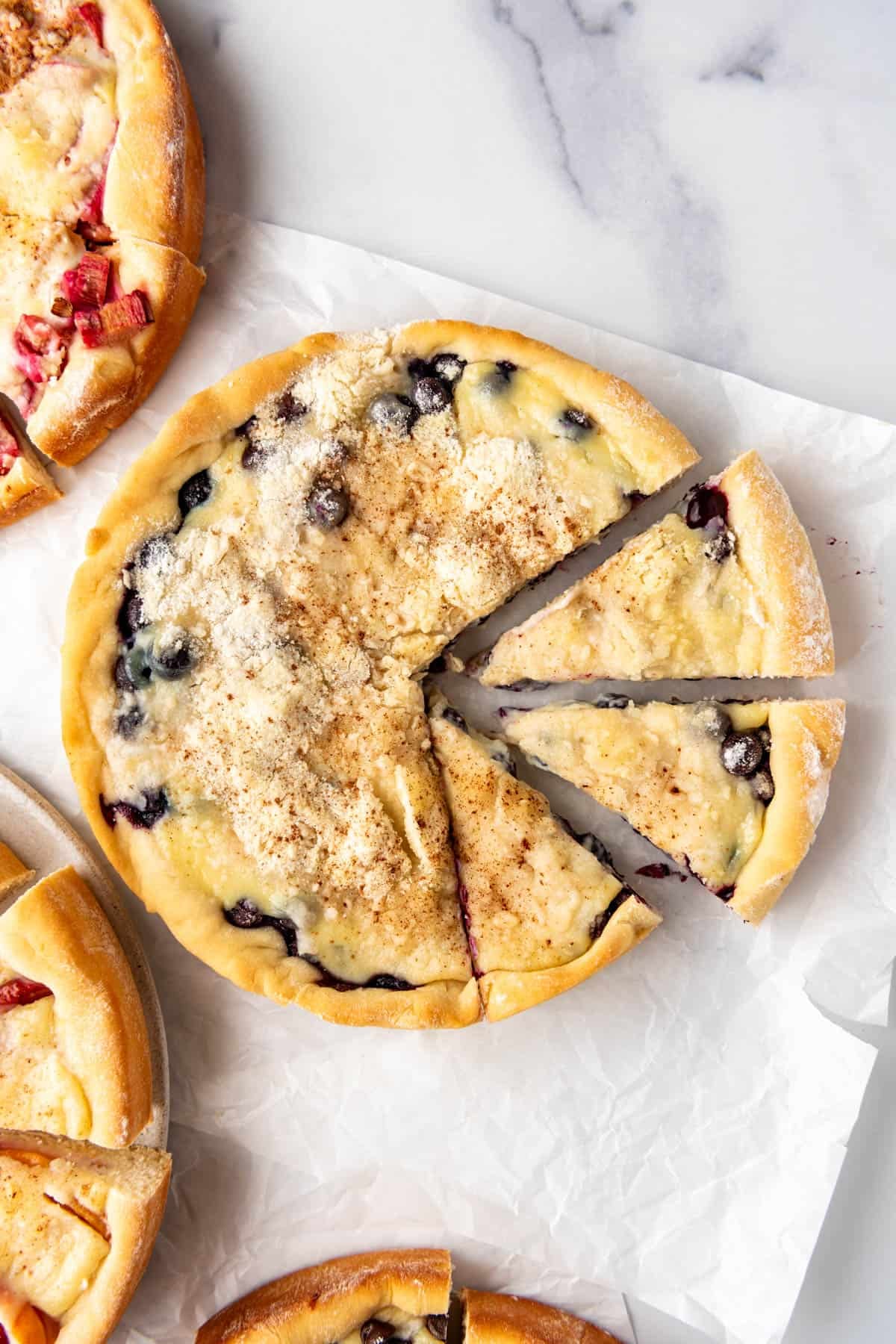 A partially sliced blueberry kuchen.