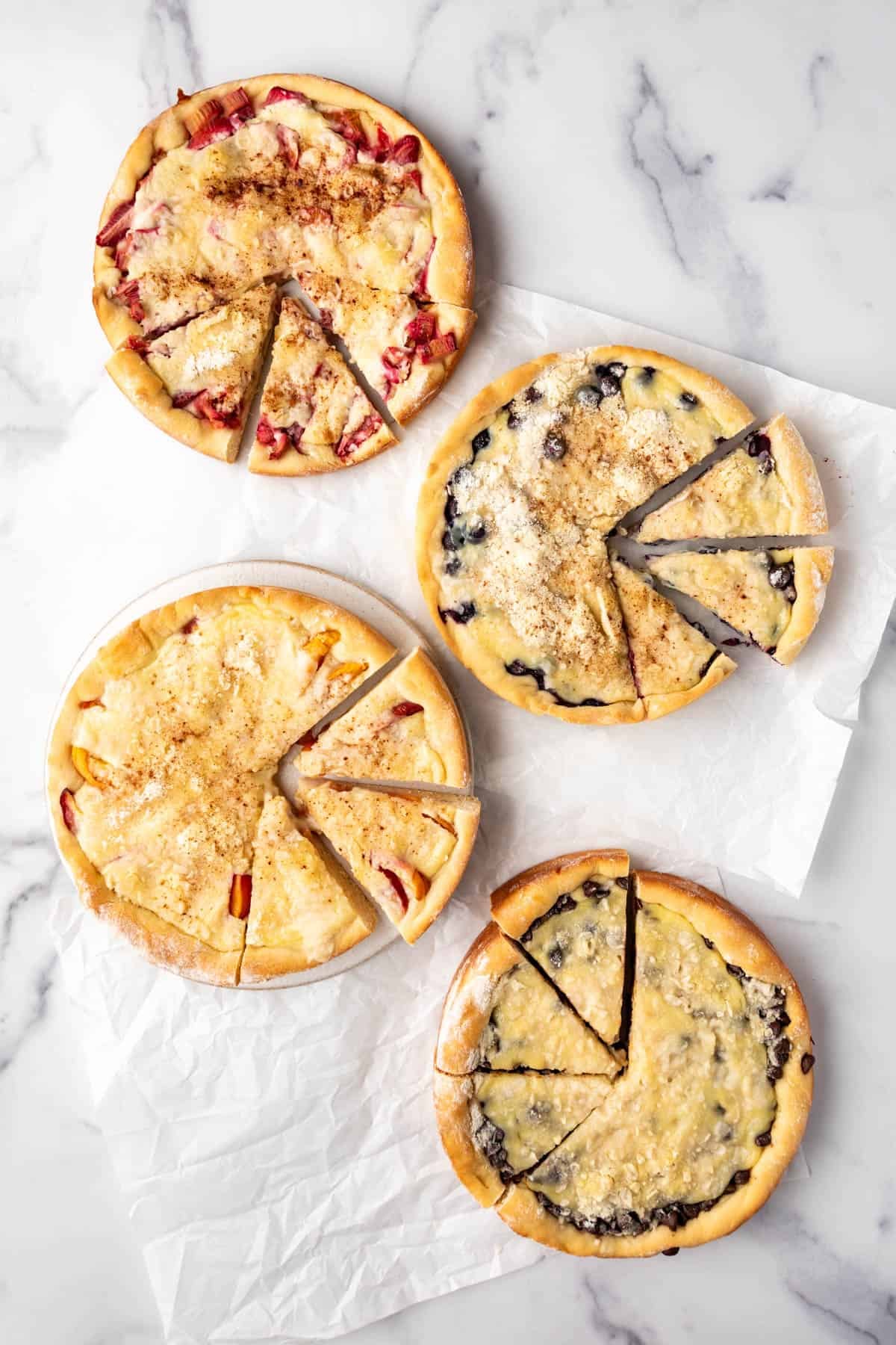An overhead image of four different flavors of kuchen.