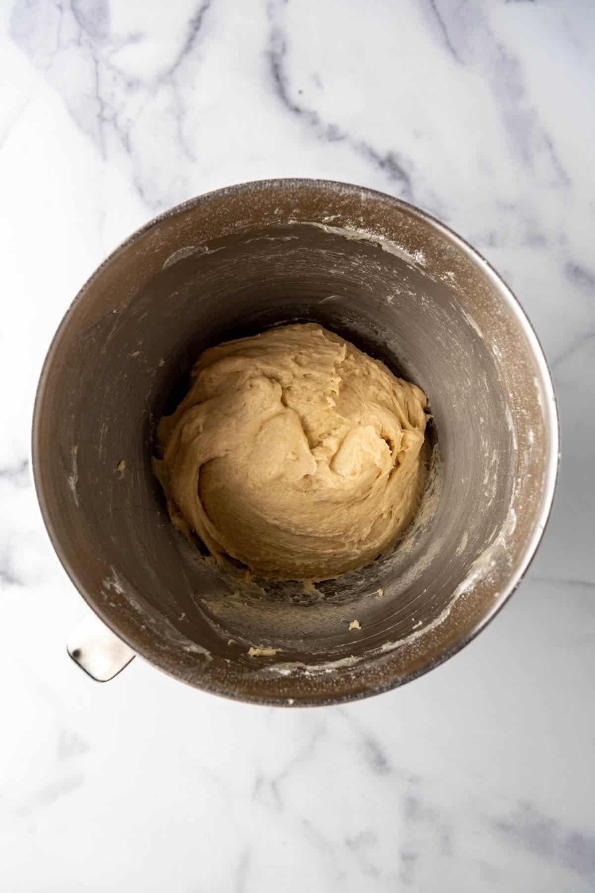 Kuchen dough in a mixing bowl before rising until doubled in size.