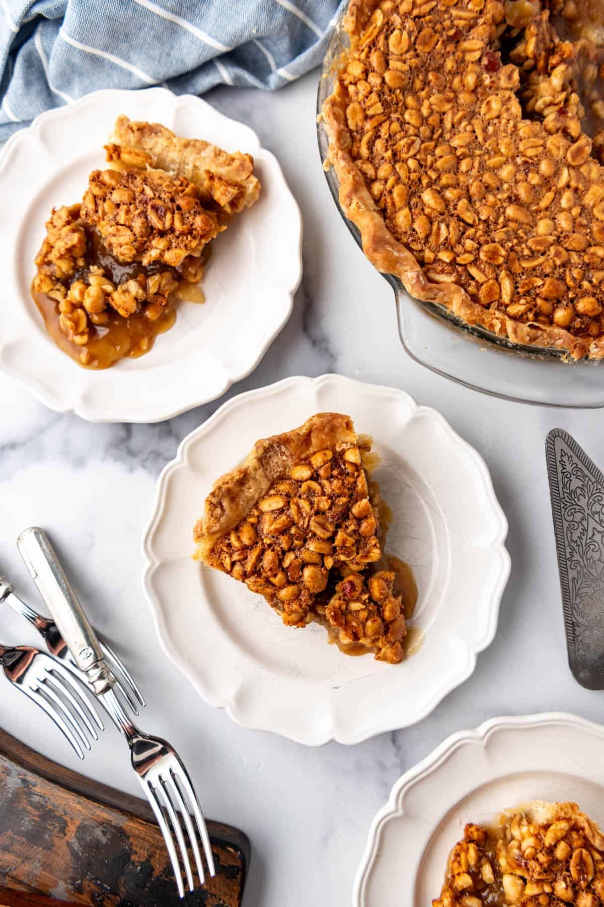 An overhead image of slices of Virginia peanut pie on white plates.