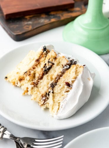 A slice of Alabama lane cake on a white plate.