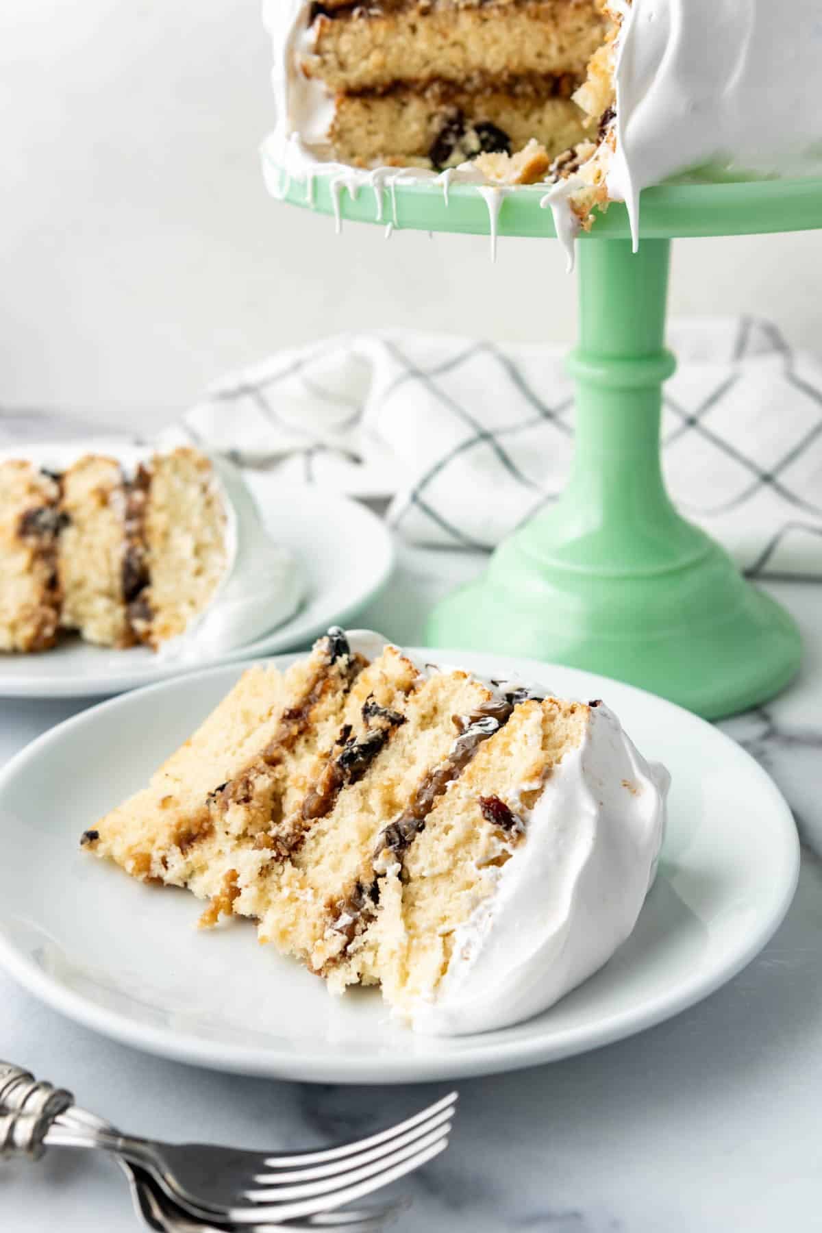 An image of slices of Alabama Lane Cake on white plates.