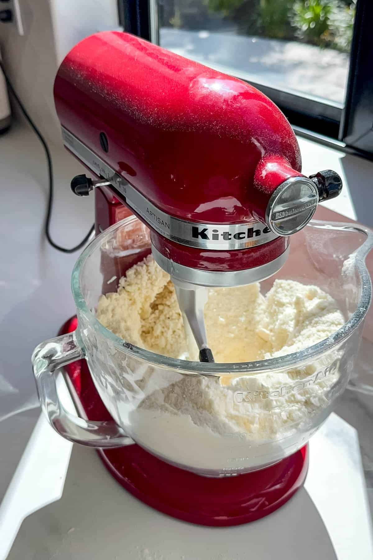 An image of a stand mixer with the start of cake batter using the reverse creaming technique.