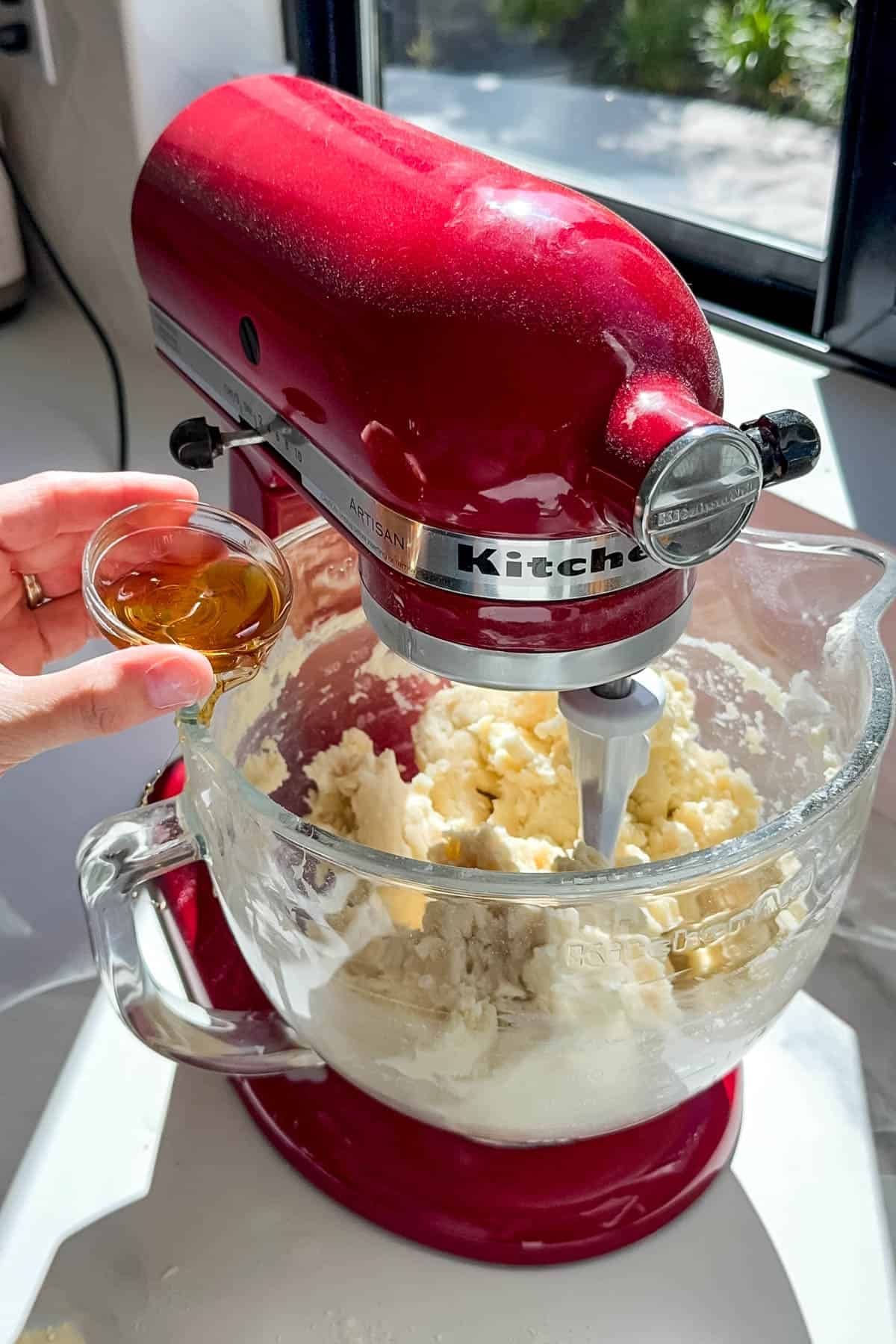 Adding vanilla to cake batter.