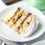 A slice of Alabama lane cake on a white plate.