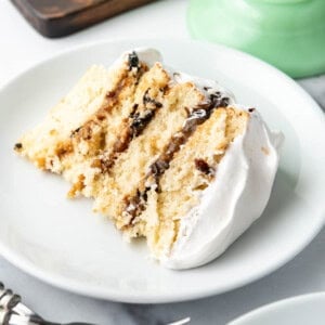 A slice of Alabama lane cake on a white plate.