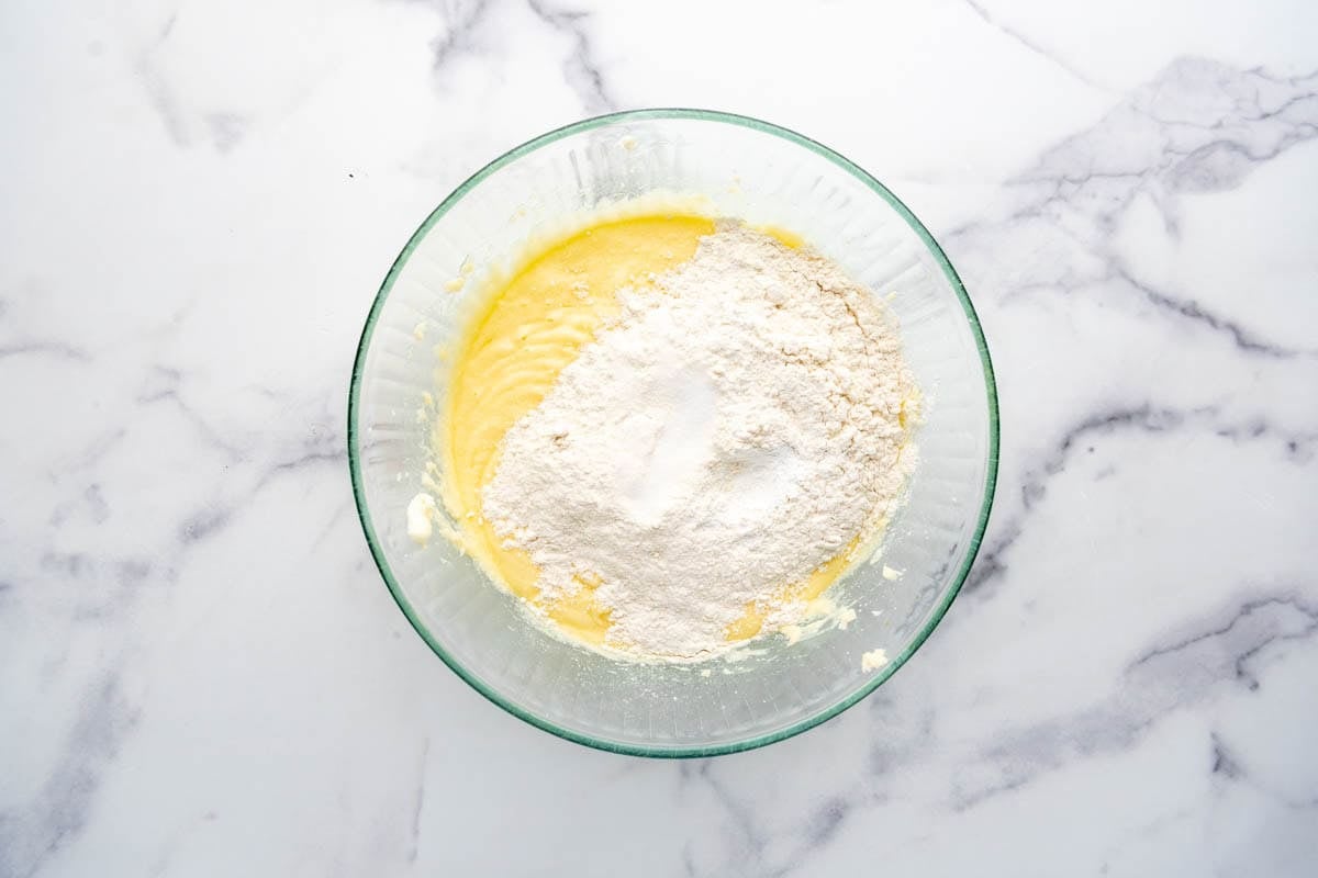 Adding dry ingredients to cake batter.