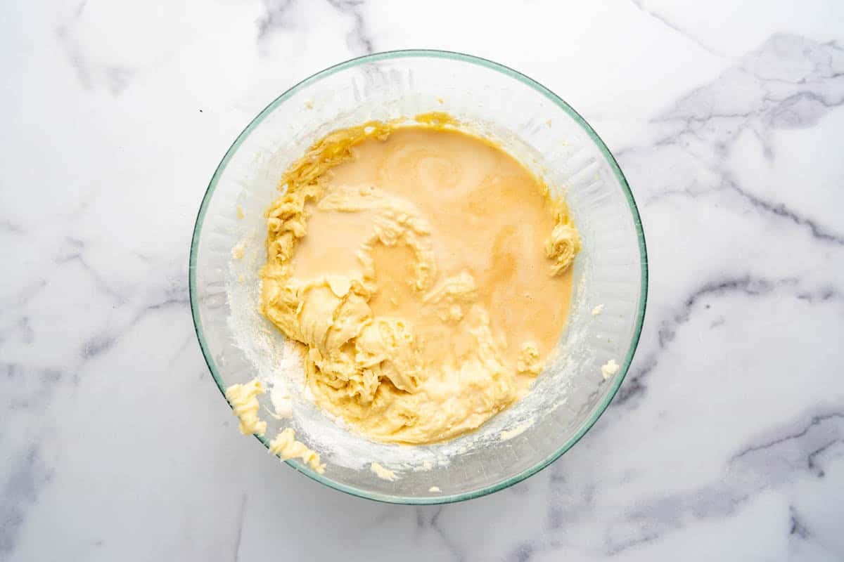 Adding wet ingredients to cake batter.