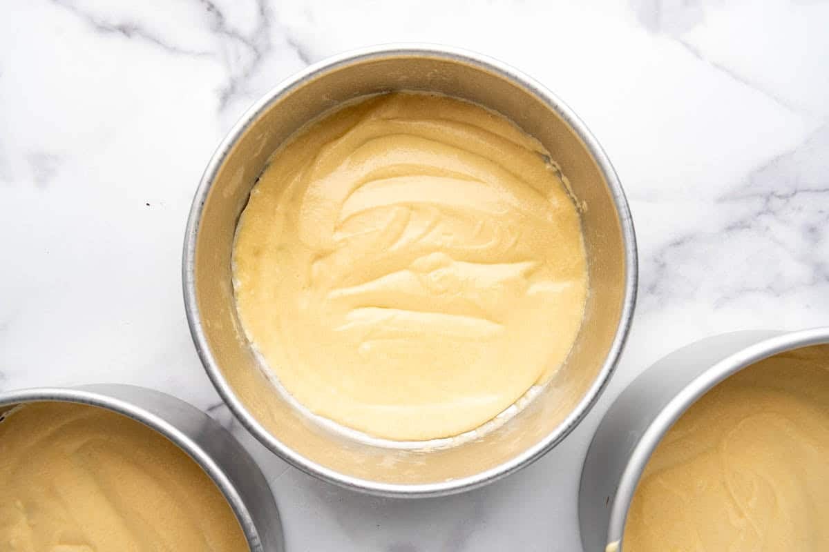Cake batter in 9-inch cake pans.