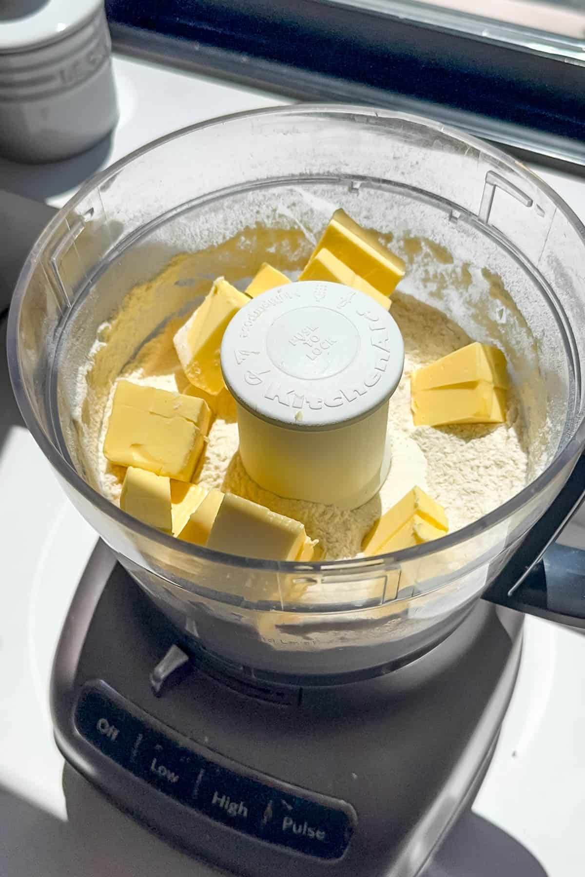 Chunks of cold butter in a food processor with flour.
