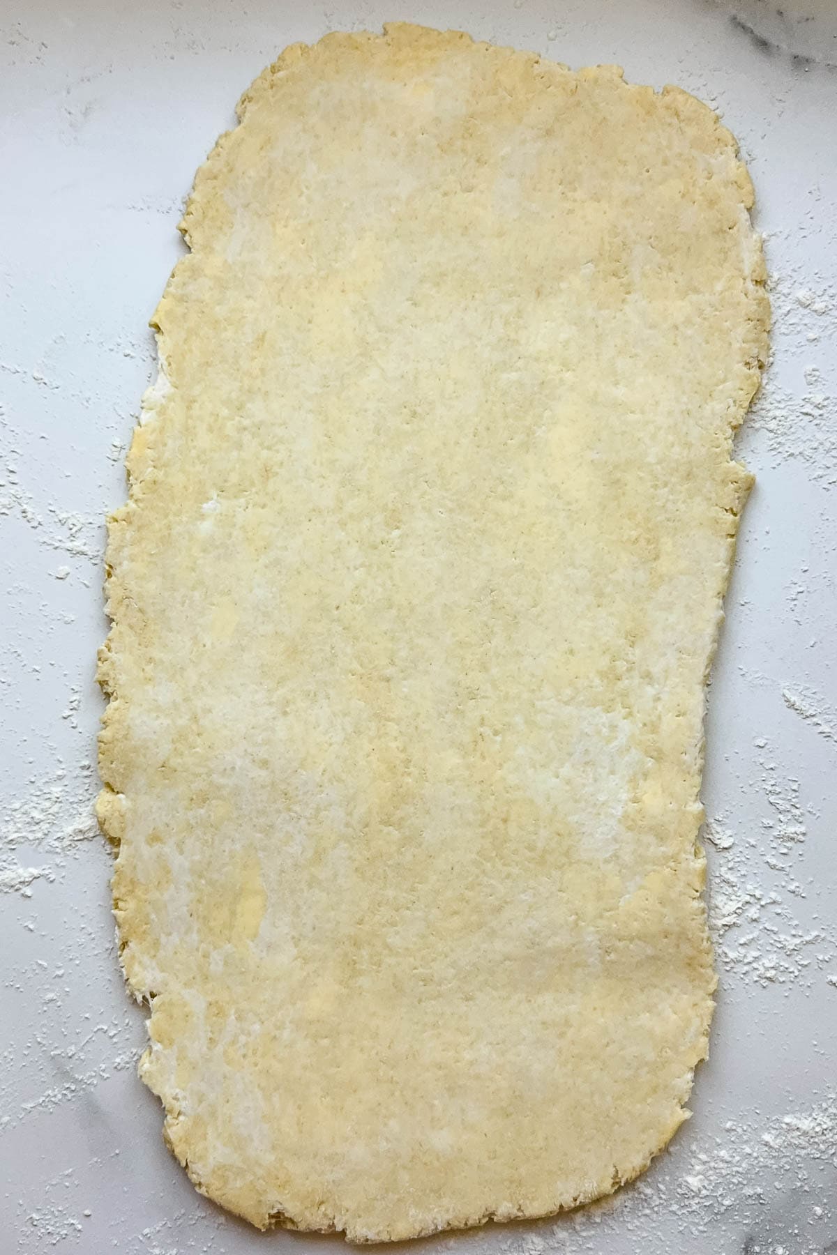An overhead image of kringle pastry dough that has been rolled out.