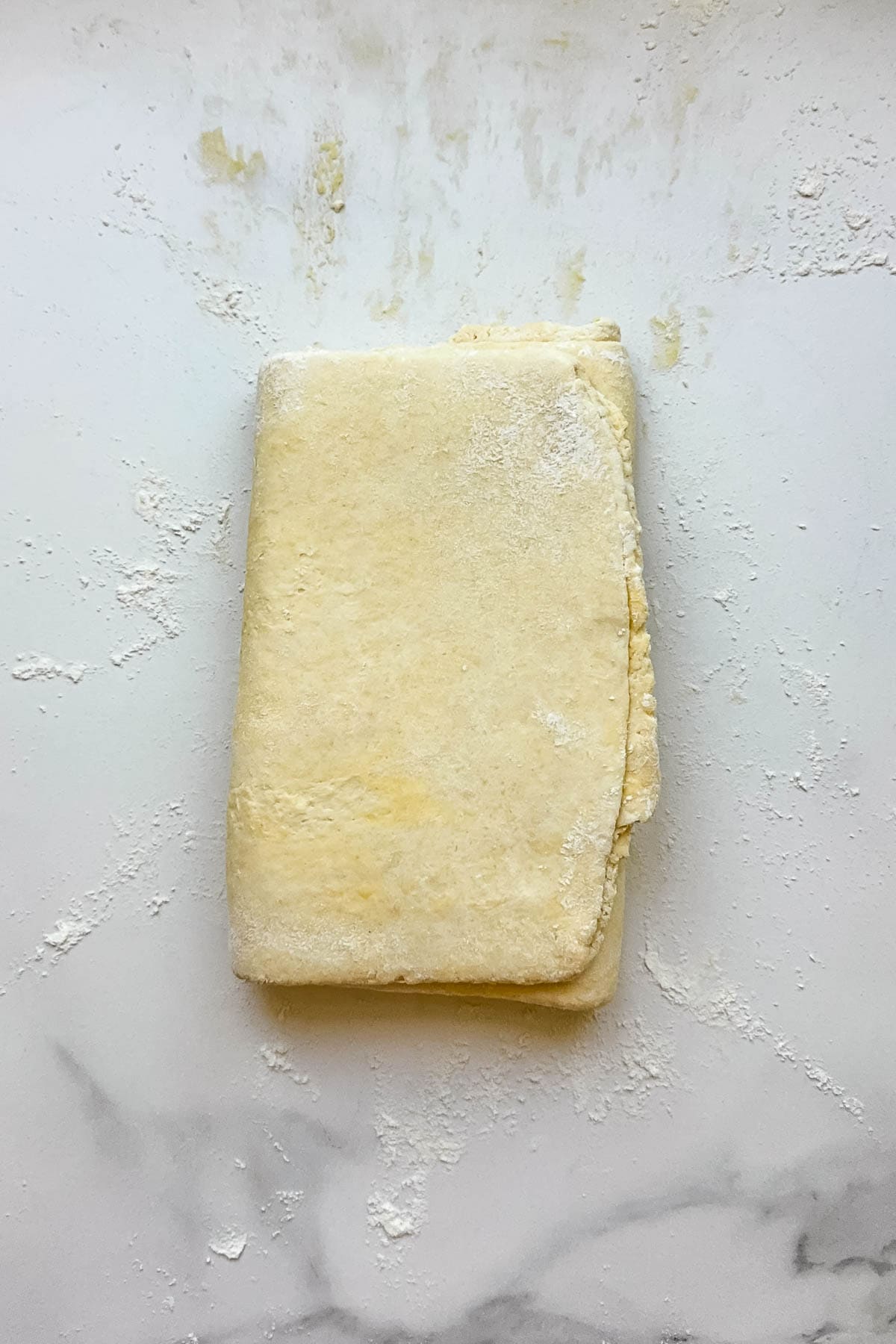 Laminated kringle dough on a floured surface.