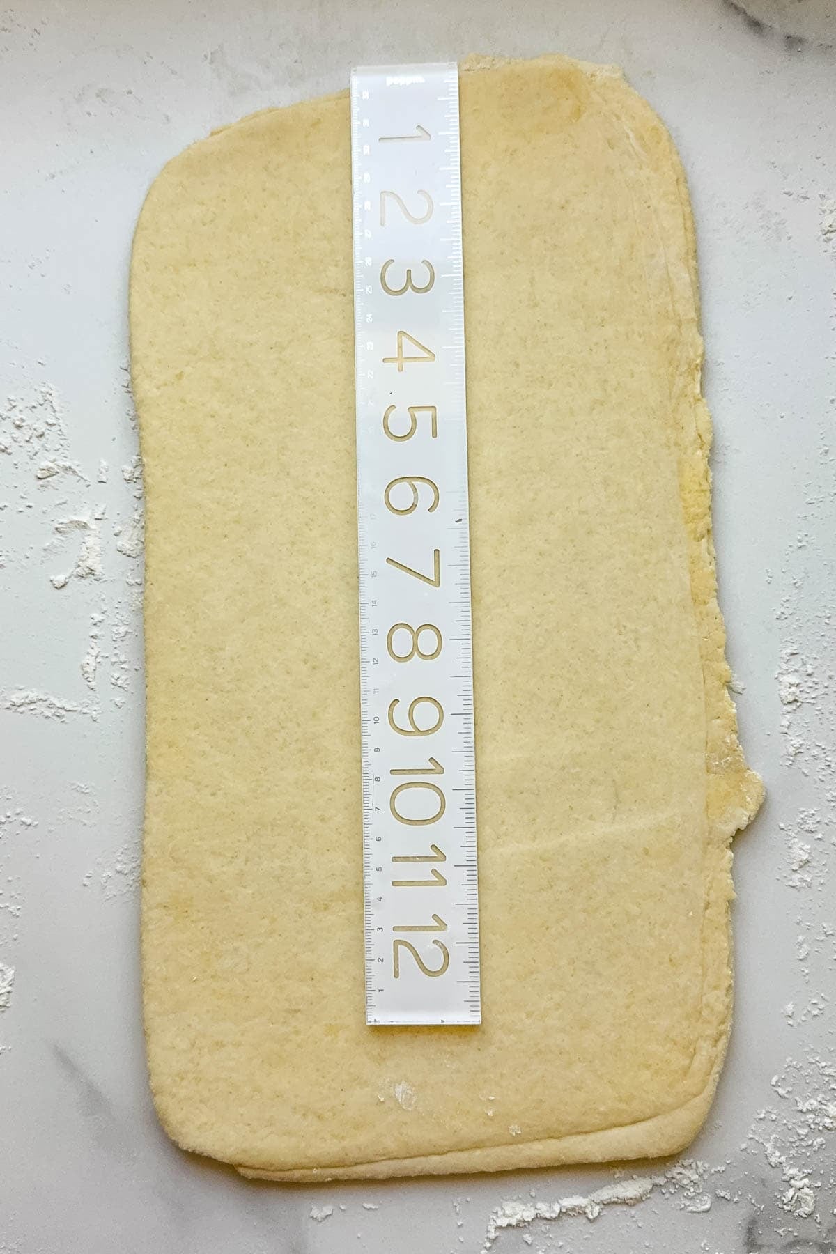 A ruler showing dough that has been rolled out 15 minutes long.