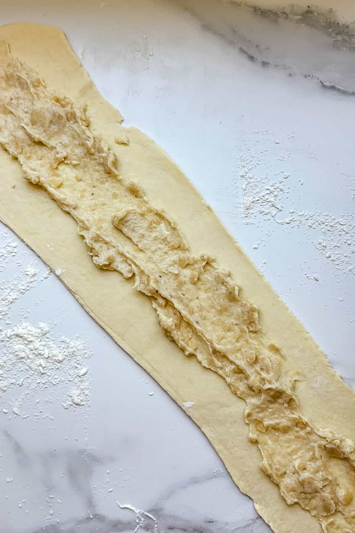 Almond filling spread on kringle dough.