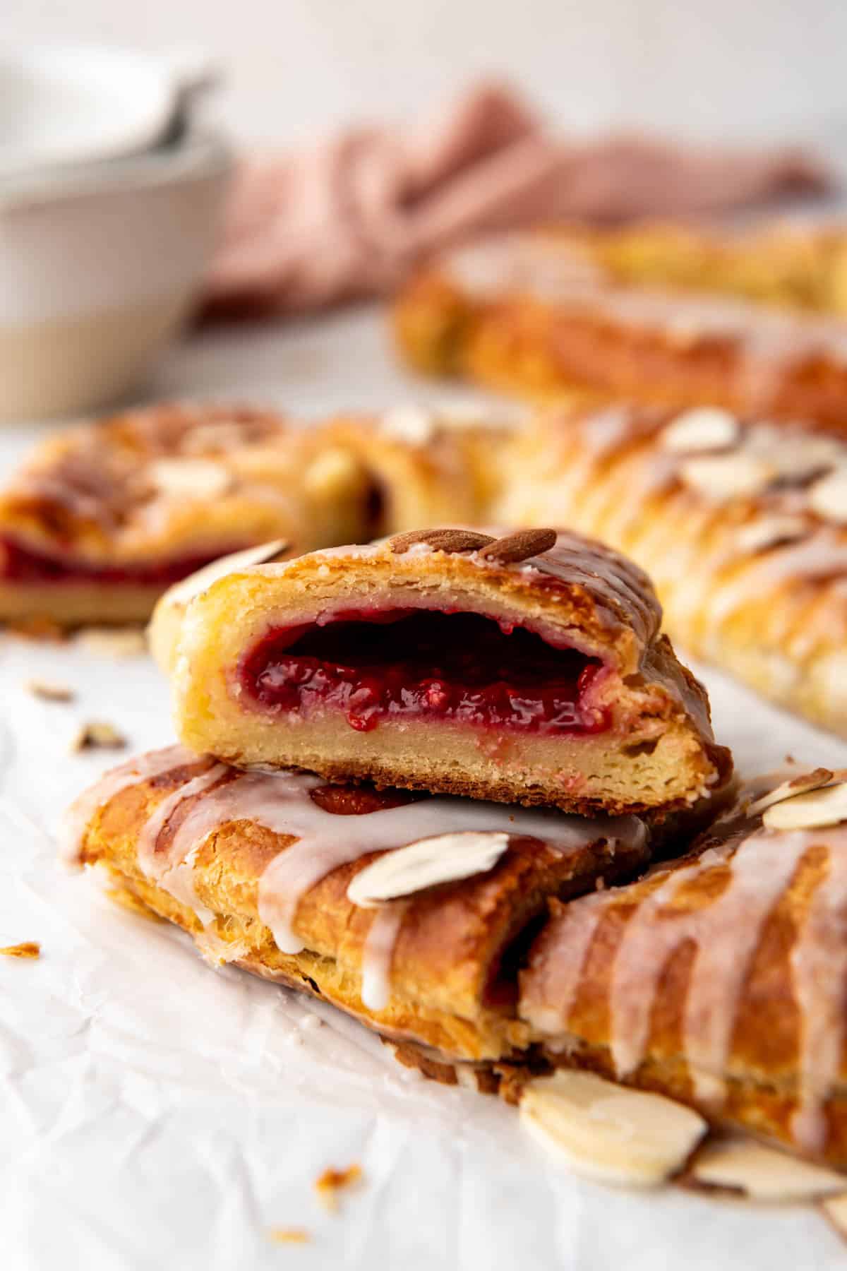 A side angle view of a raspberry kringle slice.