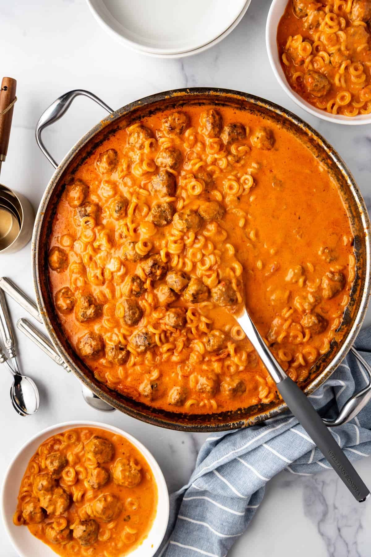 A pan of homemade spaghettios with meatballs.