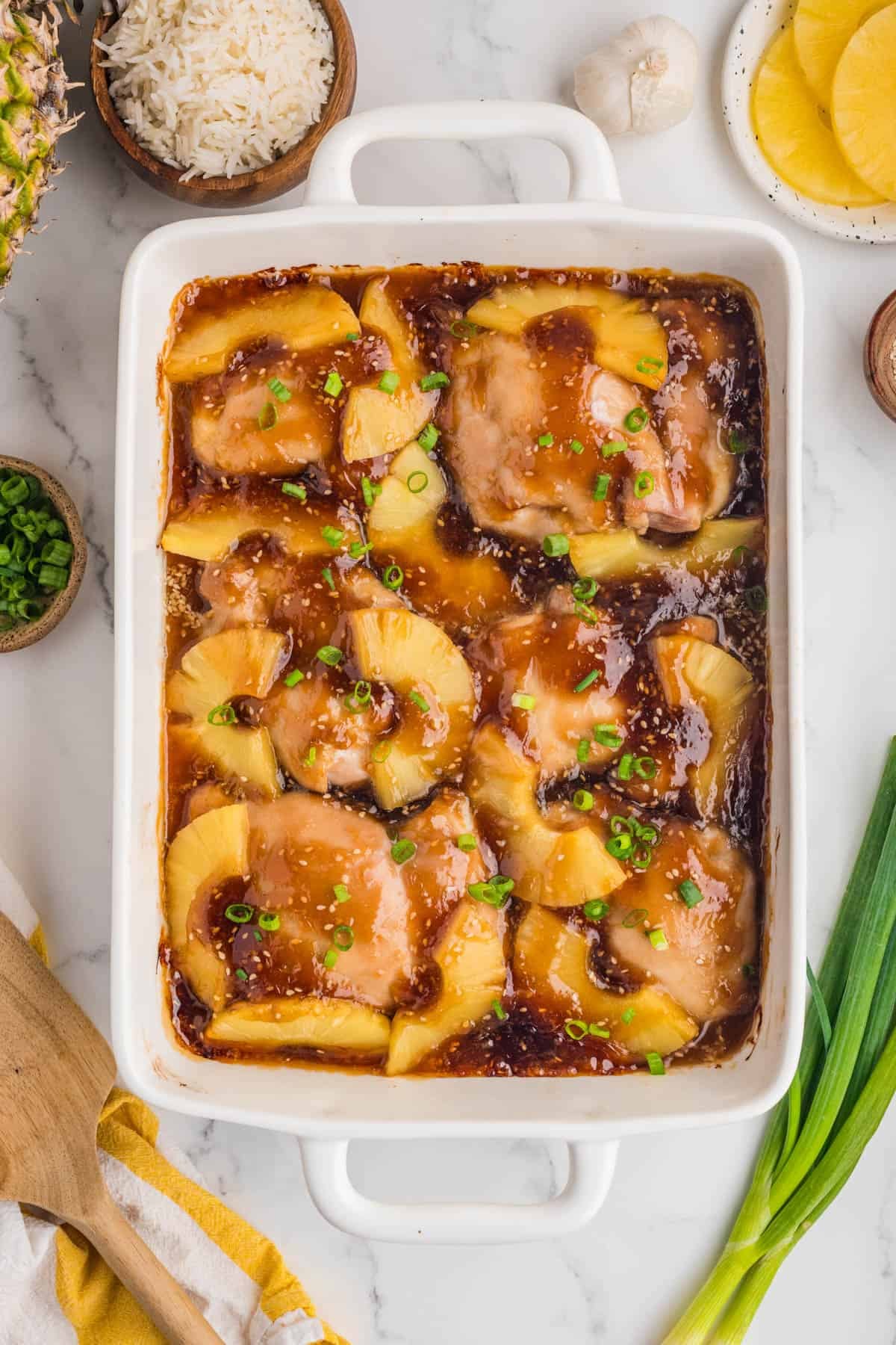 An overhead image of a pan of baked pineapple teriyaki chicken.