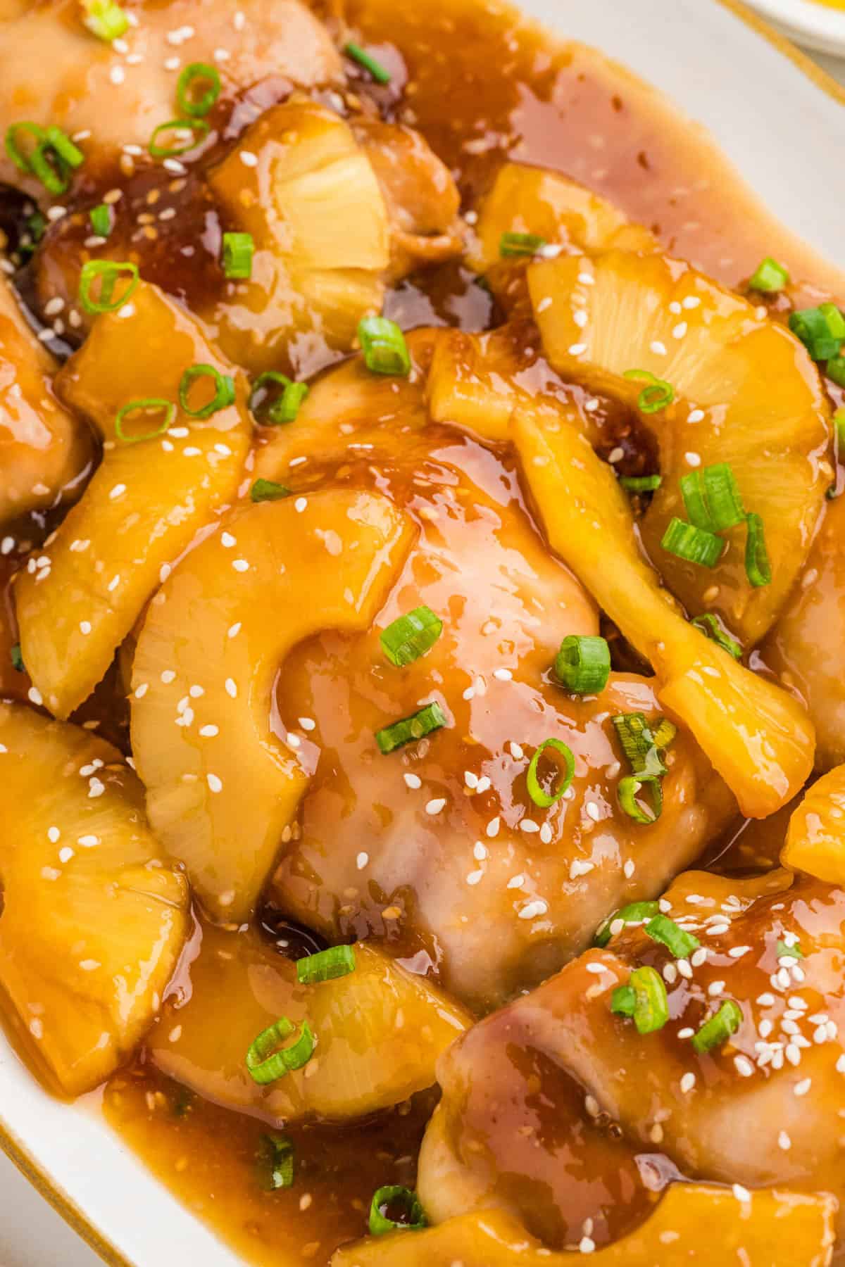 Baked pineapple teriyaki chicken on a serving platter.